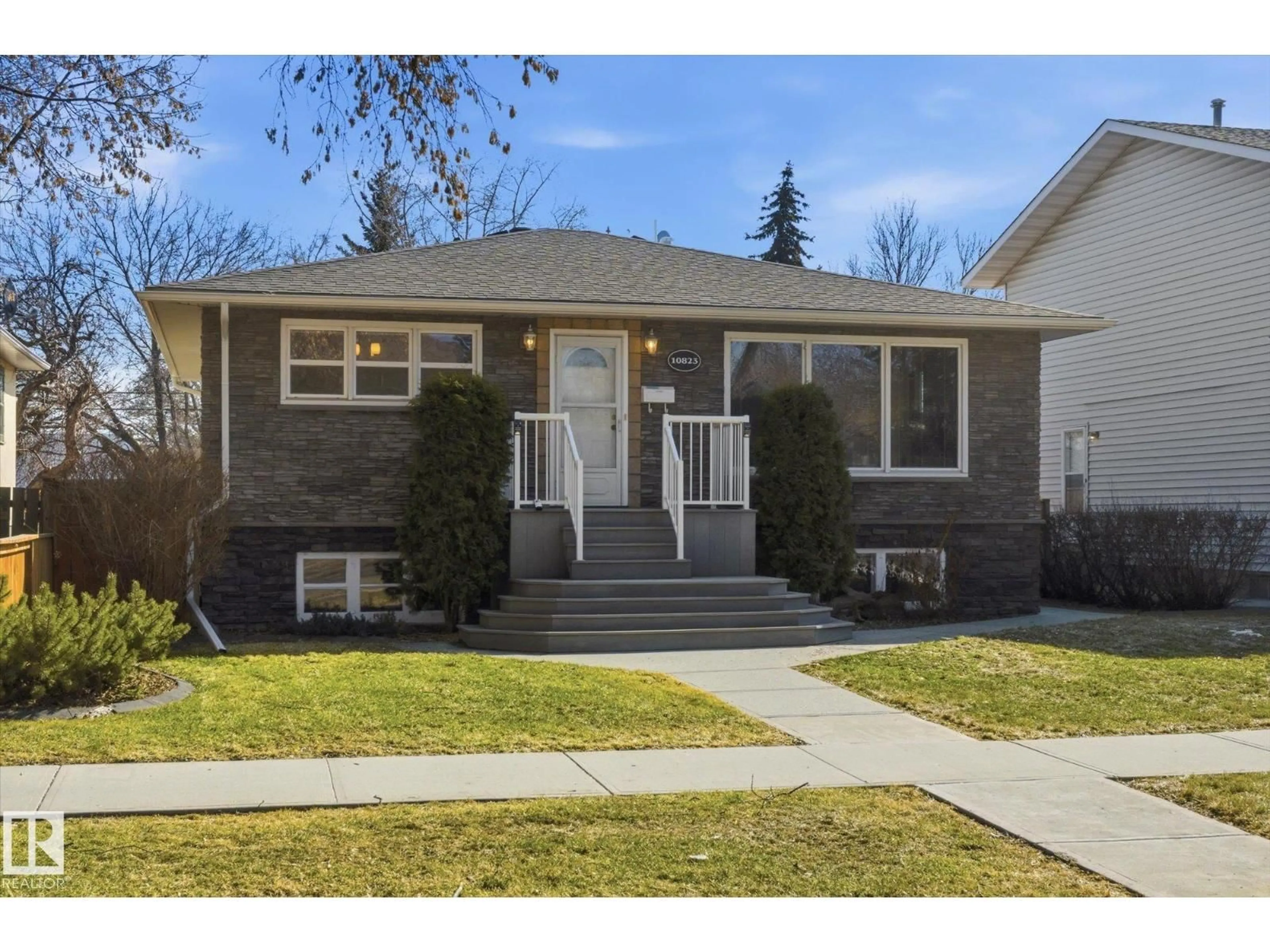 Home with vinyl exterior material, street for 10823 122 ST, Edmonton Alberta T5M0A5