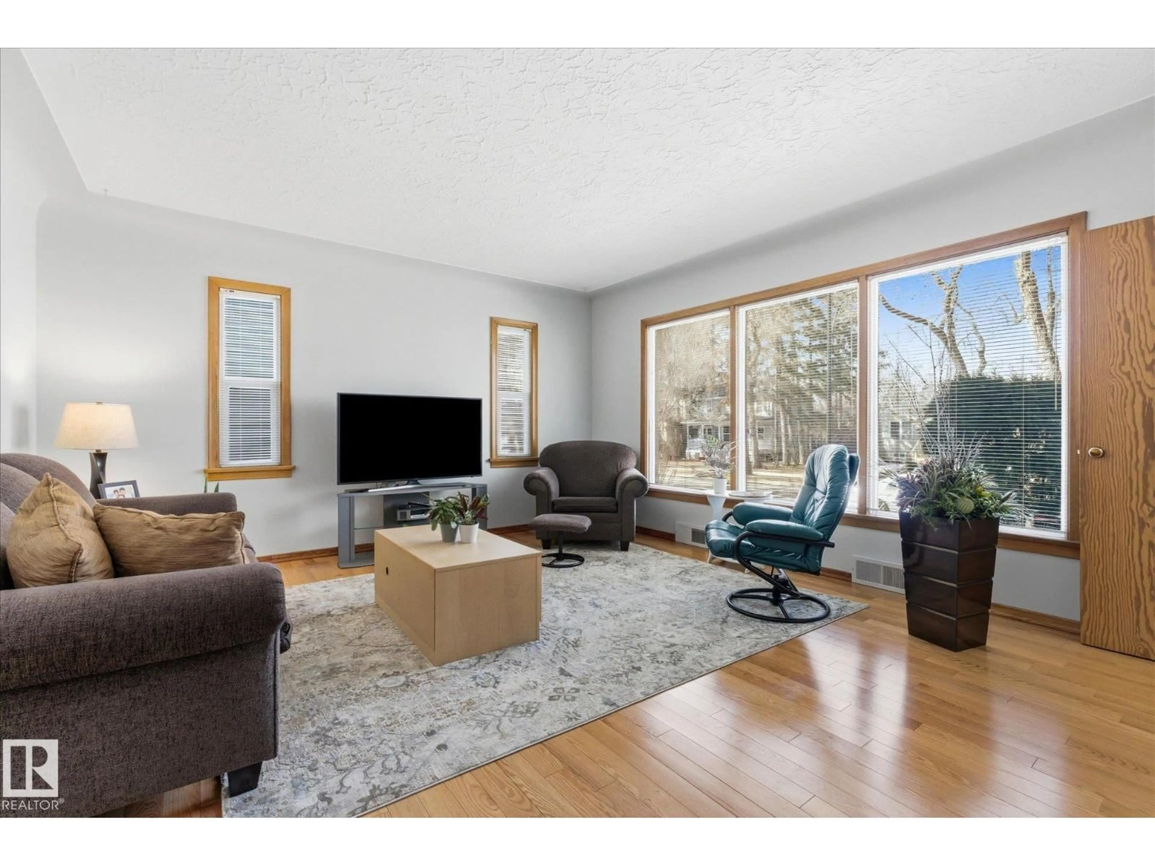 Living room with furniture, wood/laminate floor for 10823 122 ST, Edmonton Alberta T5M0A5