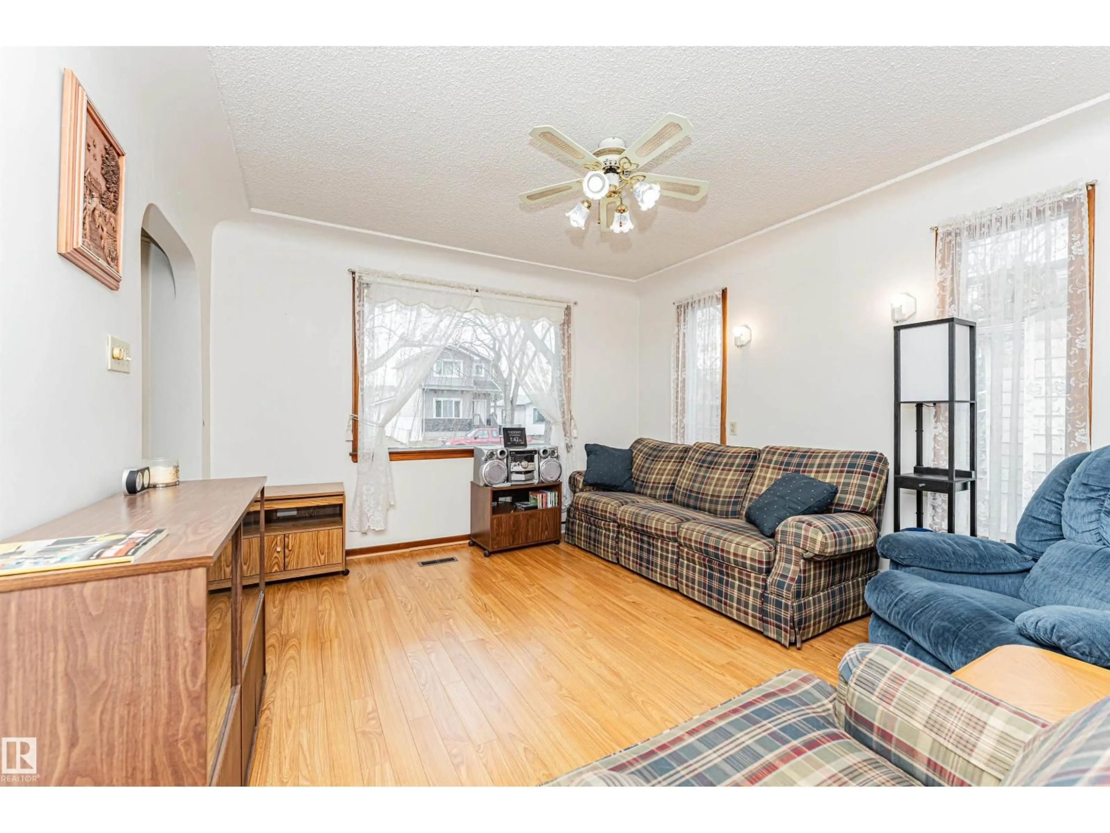 Living room with furniture, wood/laminate floor for NW - 12031 65 ST, Edmonton Alberta T5W4L6