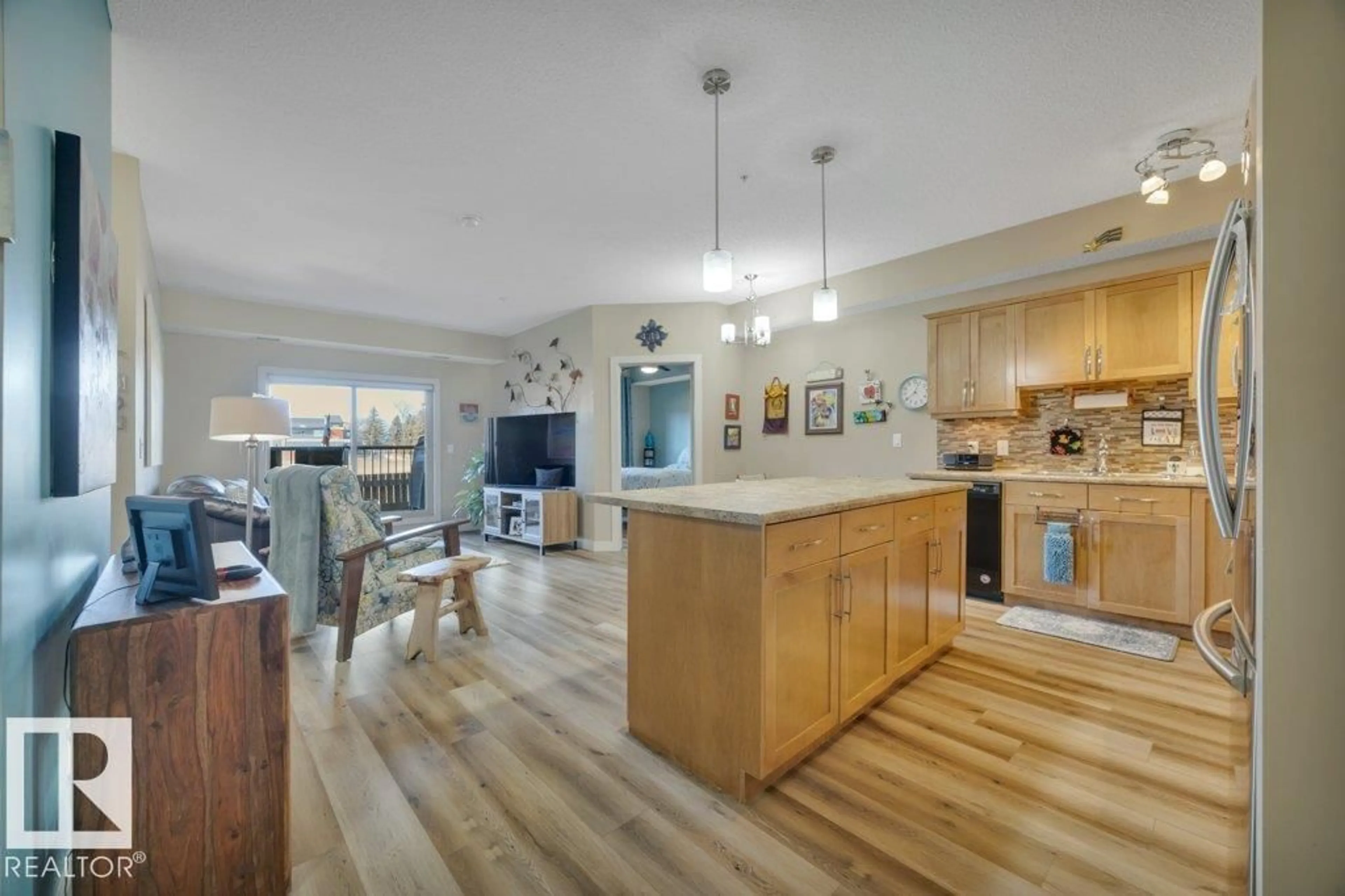 Open concept kitchen, wood/laminate floor for #110 - 10530 56 AV, Edmonton Alberta T6H0X7