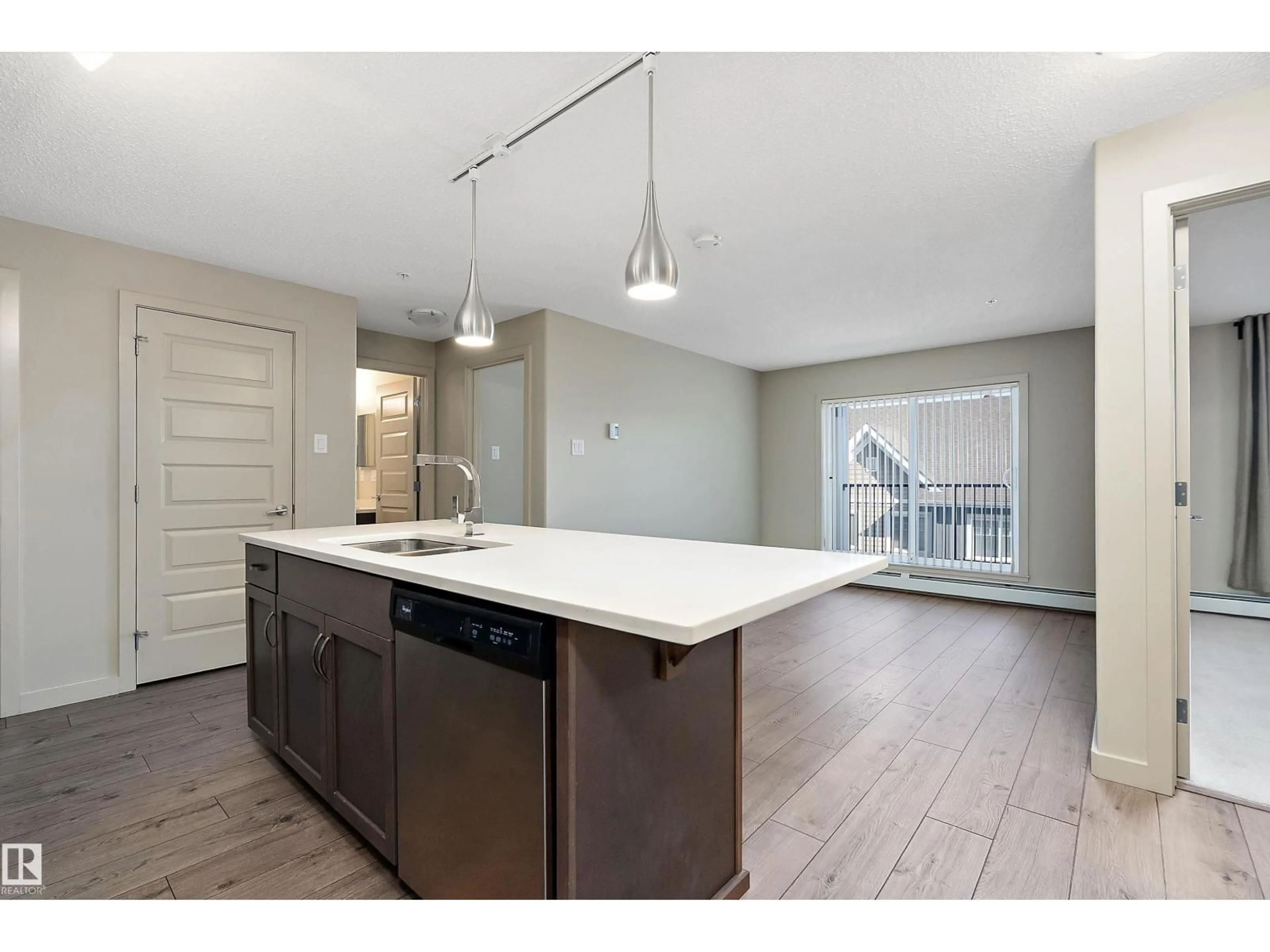 Open concept kitchen, wood/laminate floor for #309 - 4008 SAVARYN DR, Edmonton Alberta T6X2E5