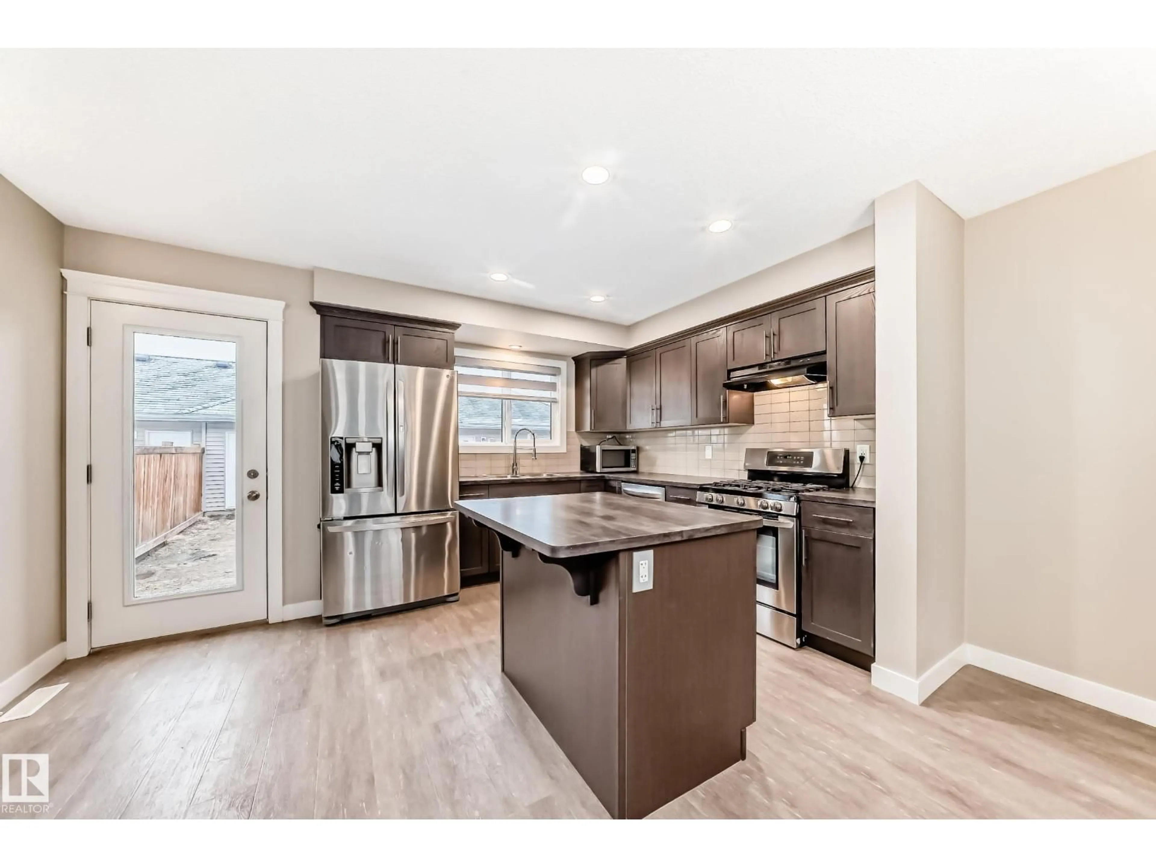 Open concept kitchen, wood/laminate floor for 5709 66 ST, Beaumont Alberta T6X2A4