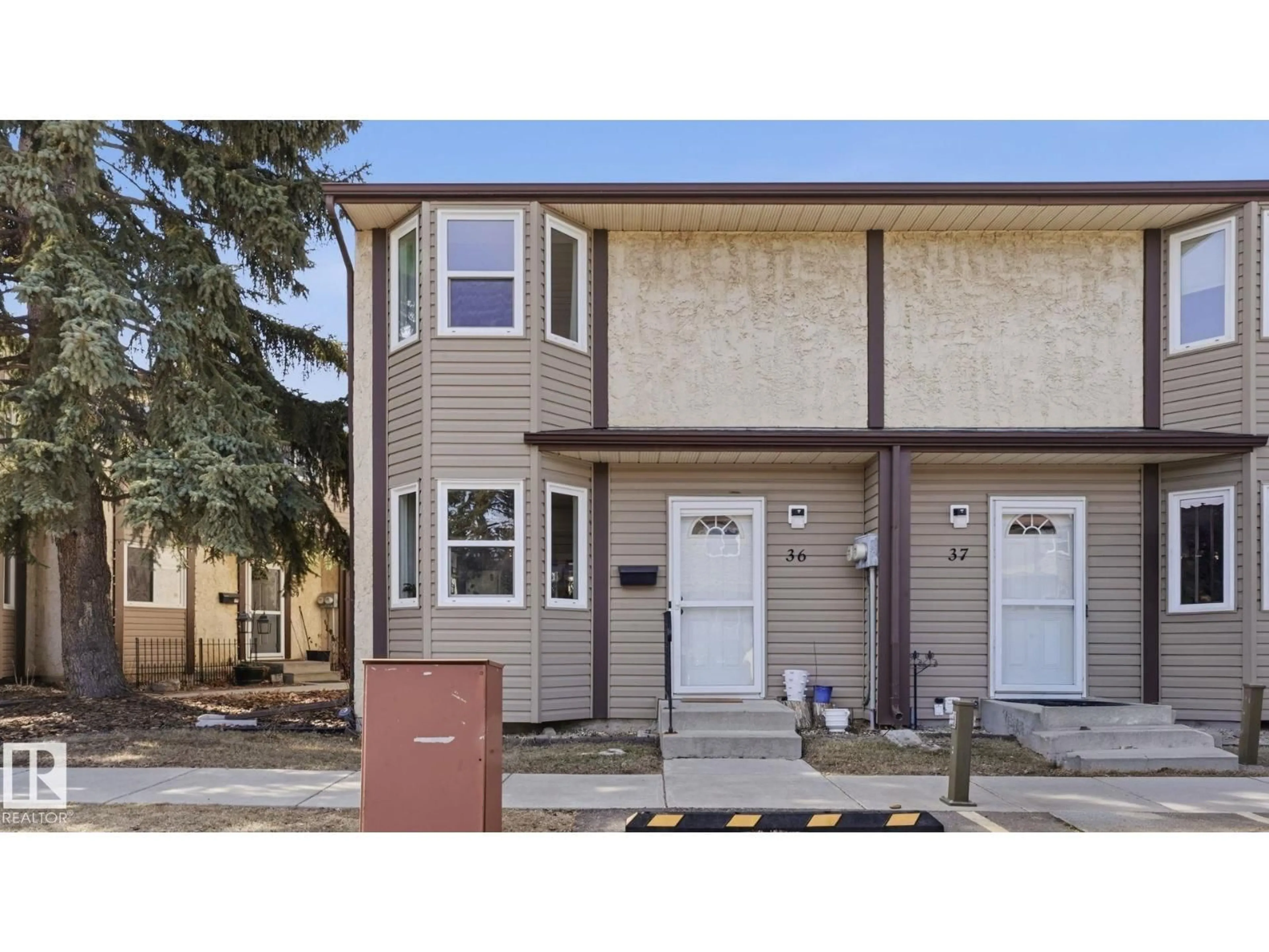 Home with vinyl exterior material, street for 36 10453 20 AV NW, Edmonton Alberta T6J5H1