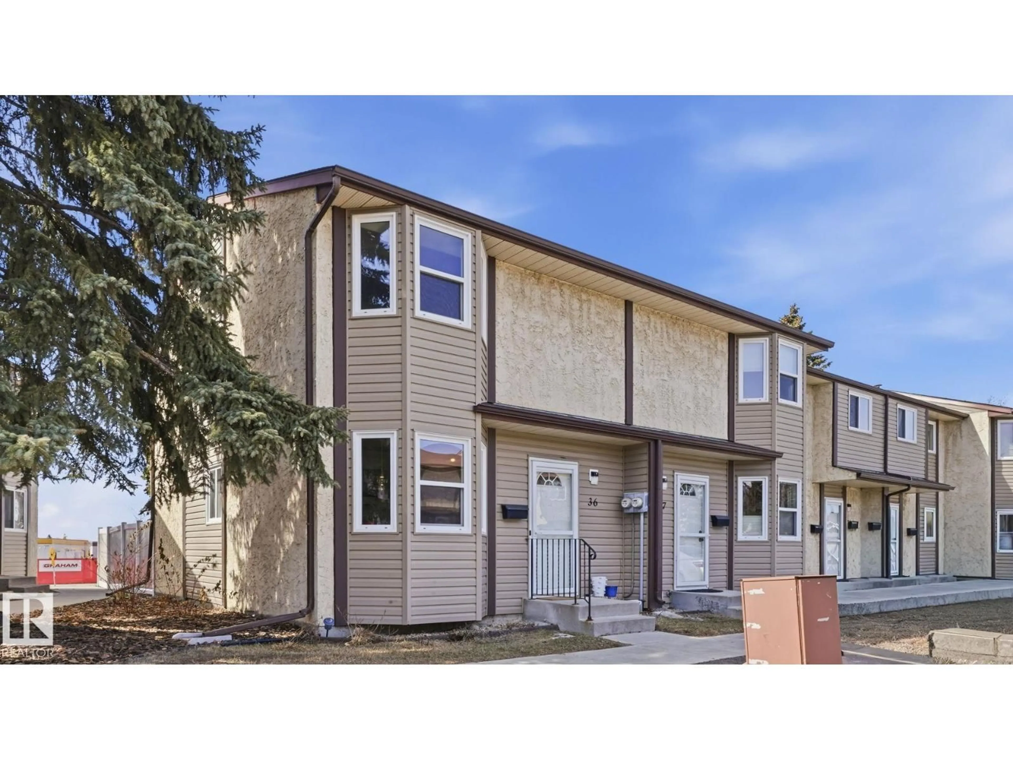 Home with vinyl exterior material, street for 36 10453 20 AV NW, Edmonton Alberta T6J5H1