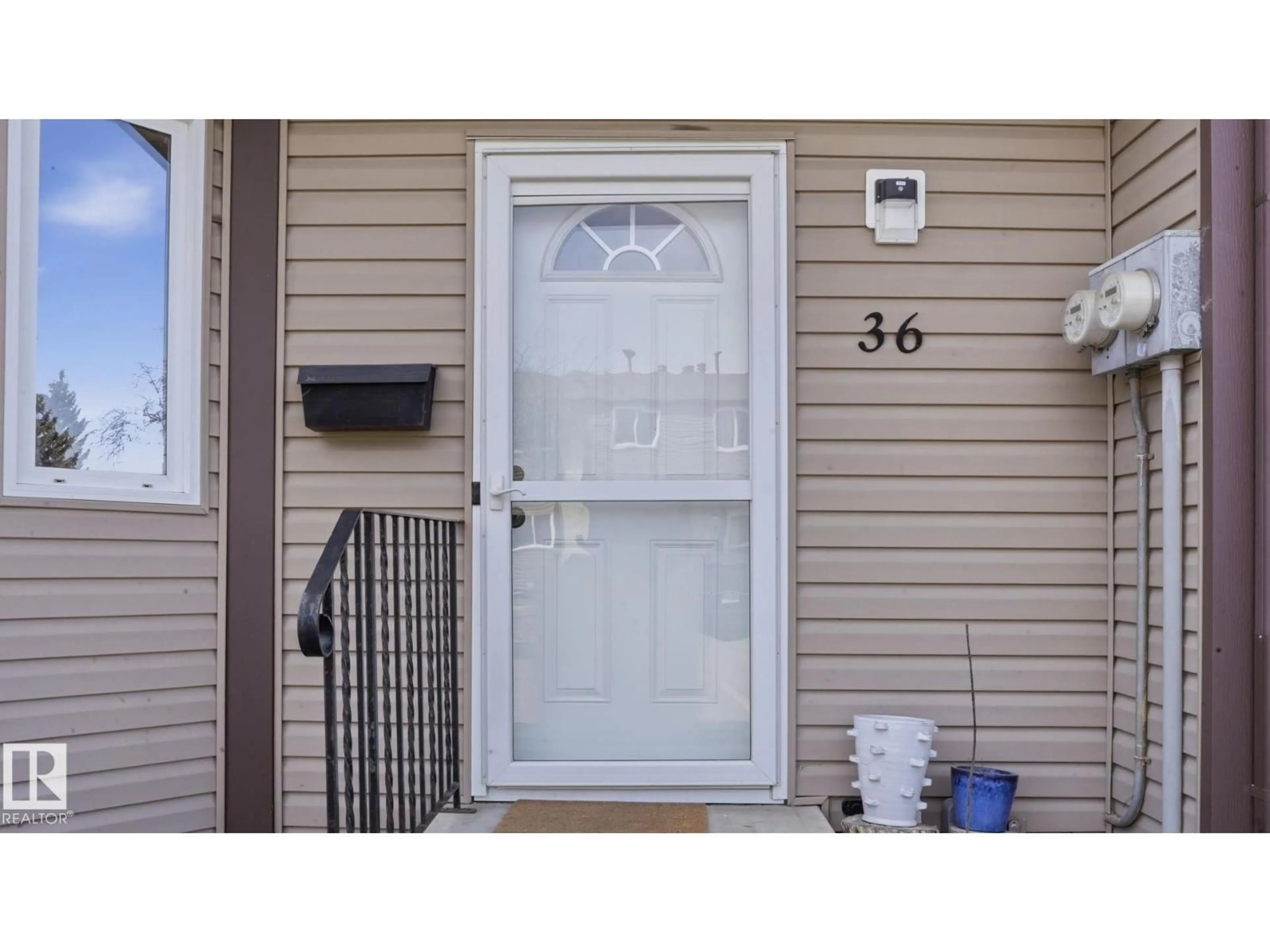 Home with vinyl exterior material, street for 36 10453 20 AV NW, Edmonton Alberta T6J5H1