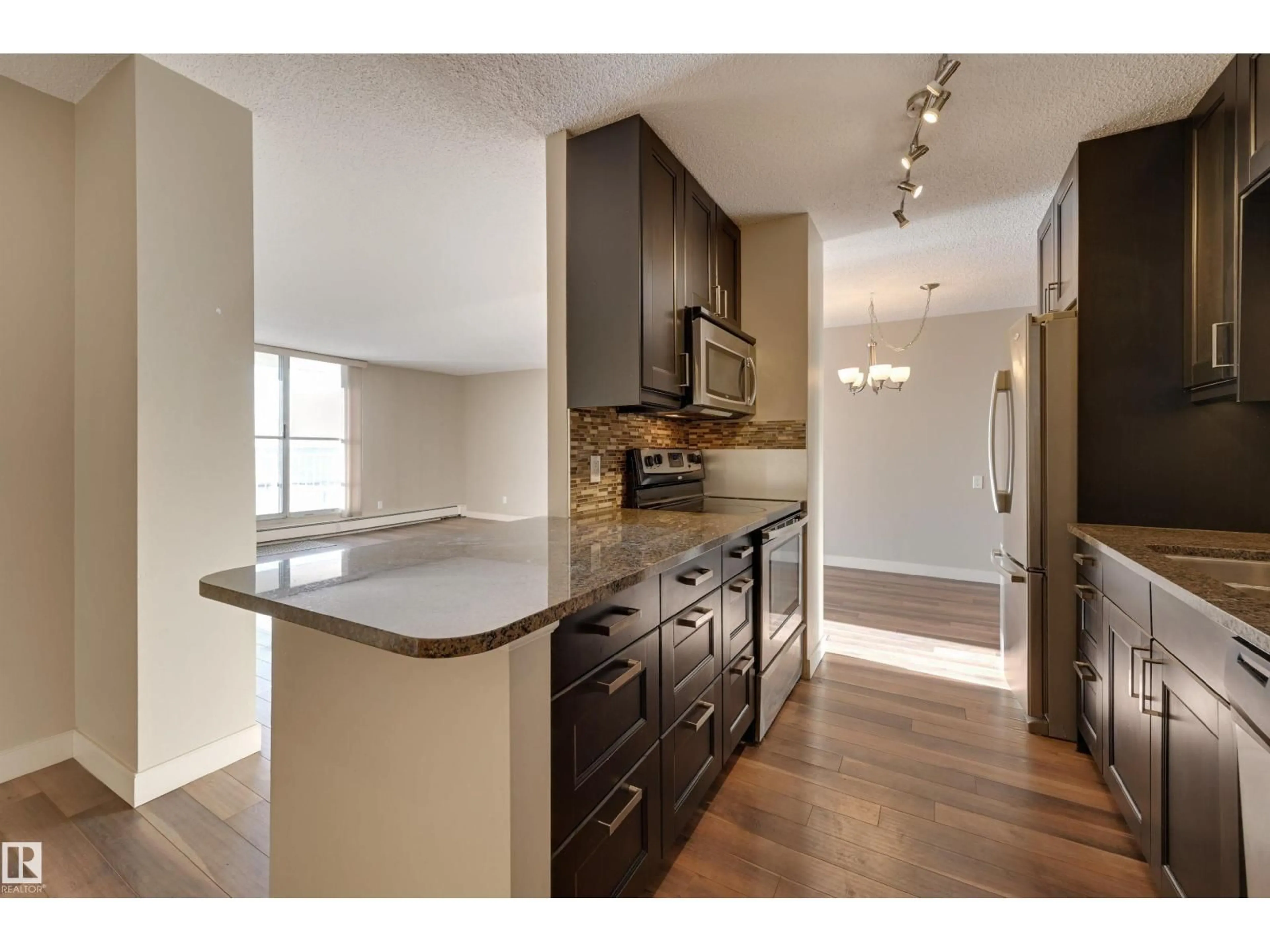 Open concept kitchen, wood/laminate floor for #406 - 12141 JASPER AV, Edmonton Alberta T5N3X8