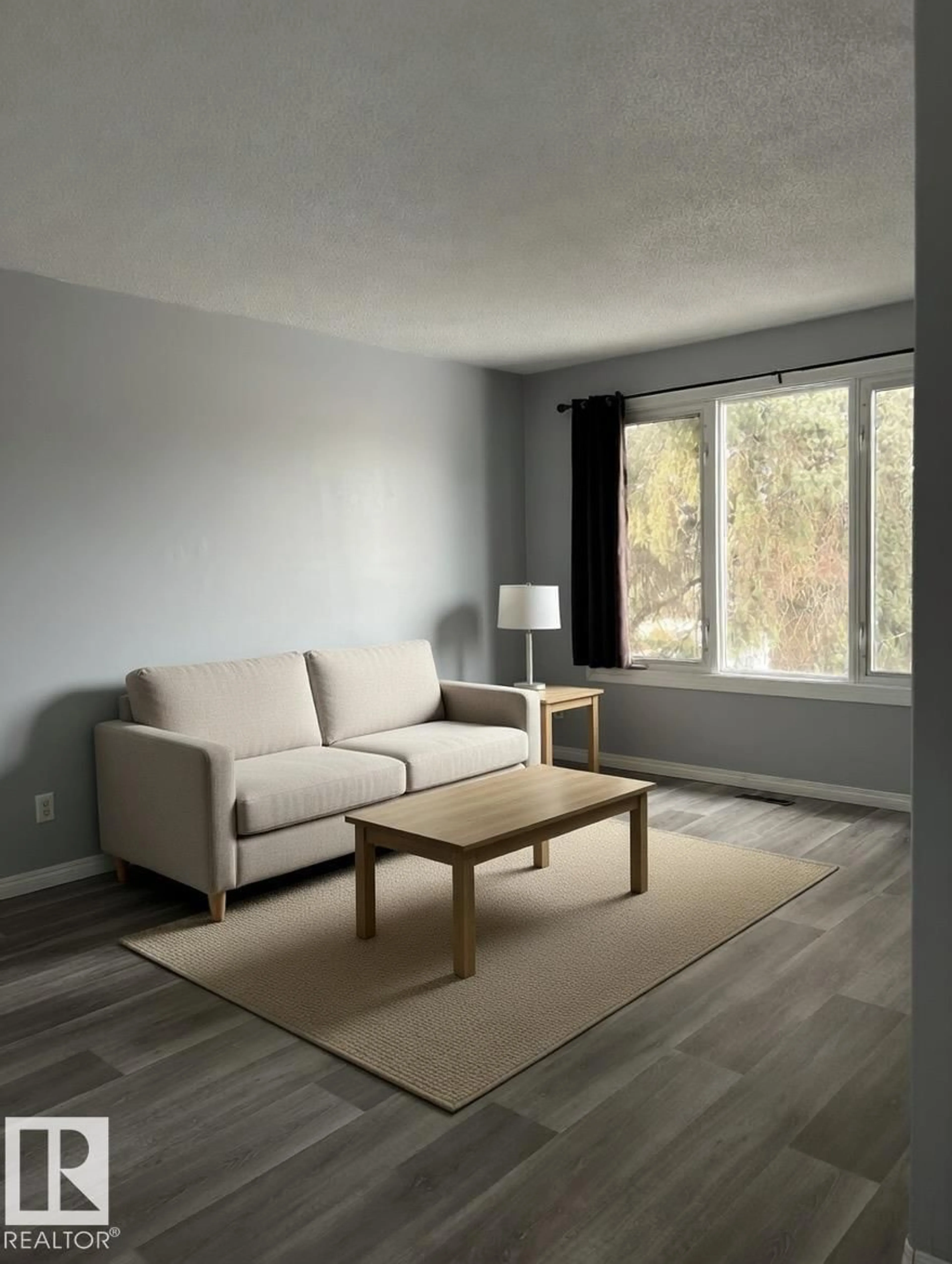 Living room with furniture, wood/laminate floor for 6333 11 AV, Edmonton Alberta T6L3A8