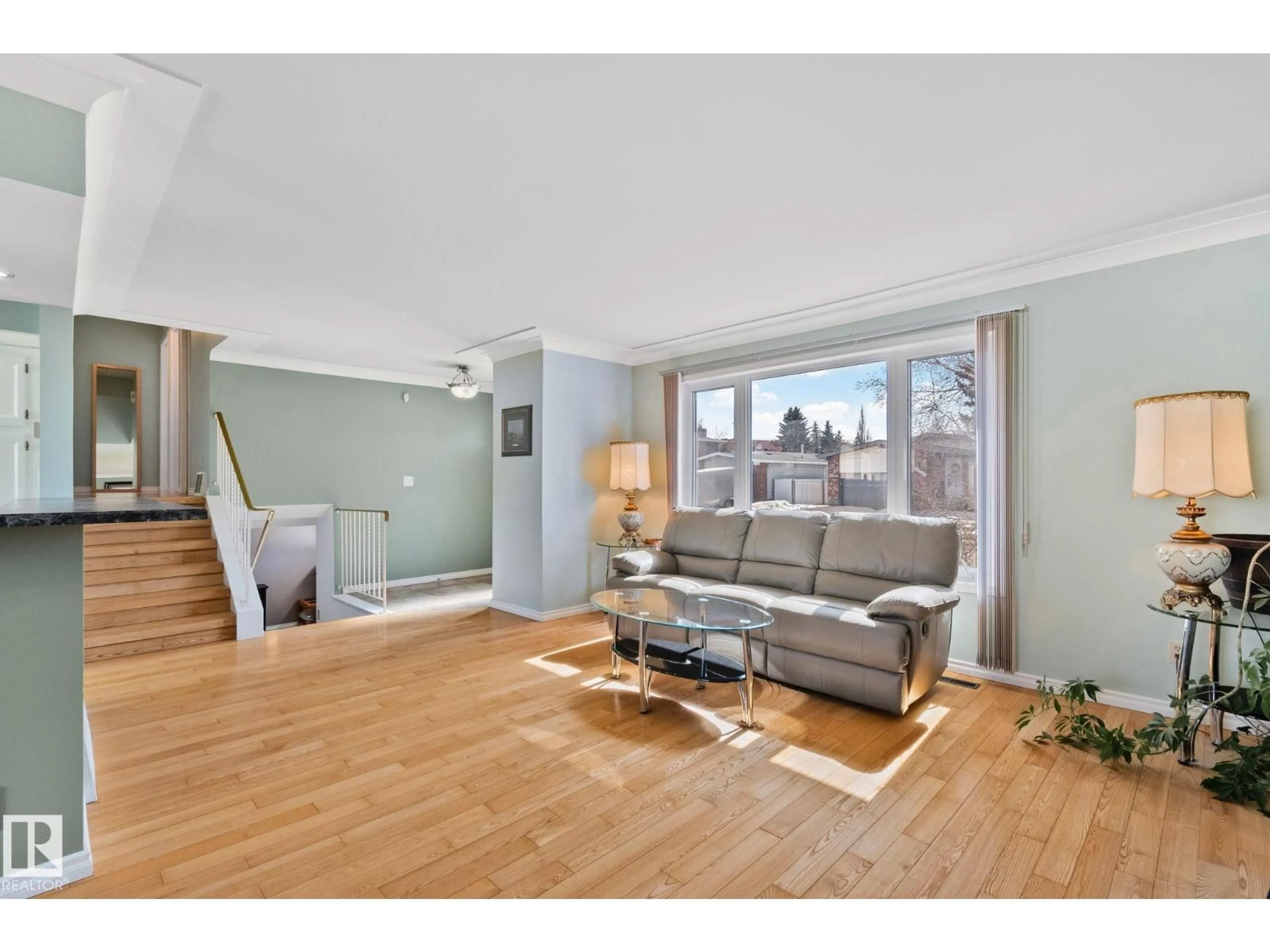 Living room with furniture, wood/laminate floor for NW - 2016 138 AV, Edmonton Alberta T5Y1K6