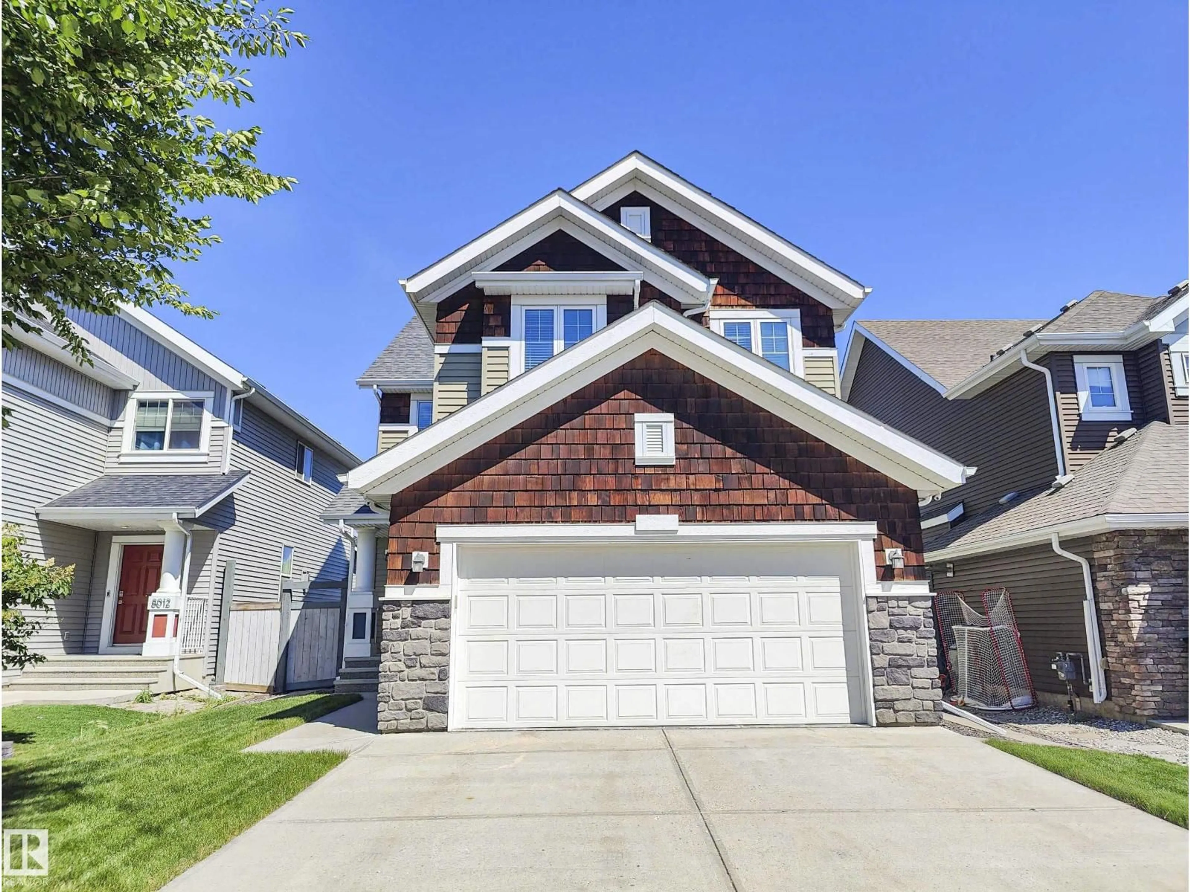 Home with vinyl exterior material, street for 8008 18 AV SW, Edmonton Alberta T6X0Z8