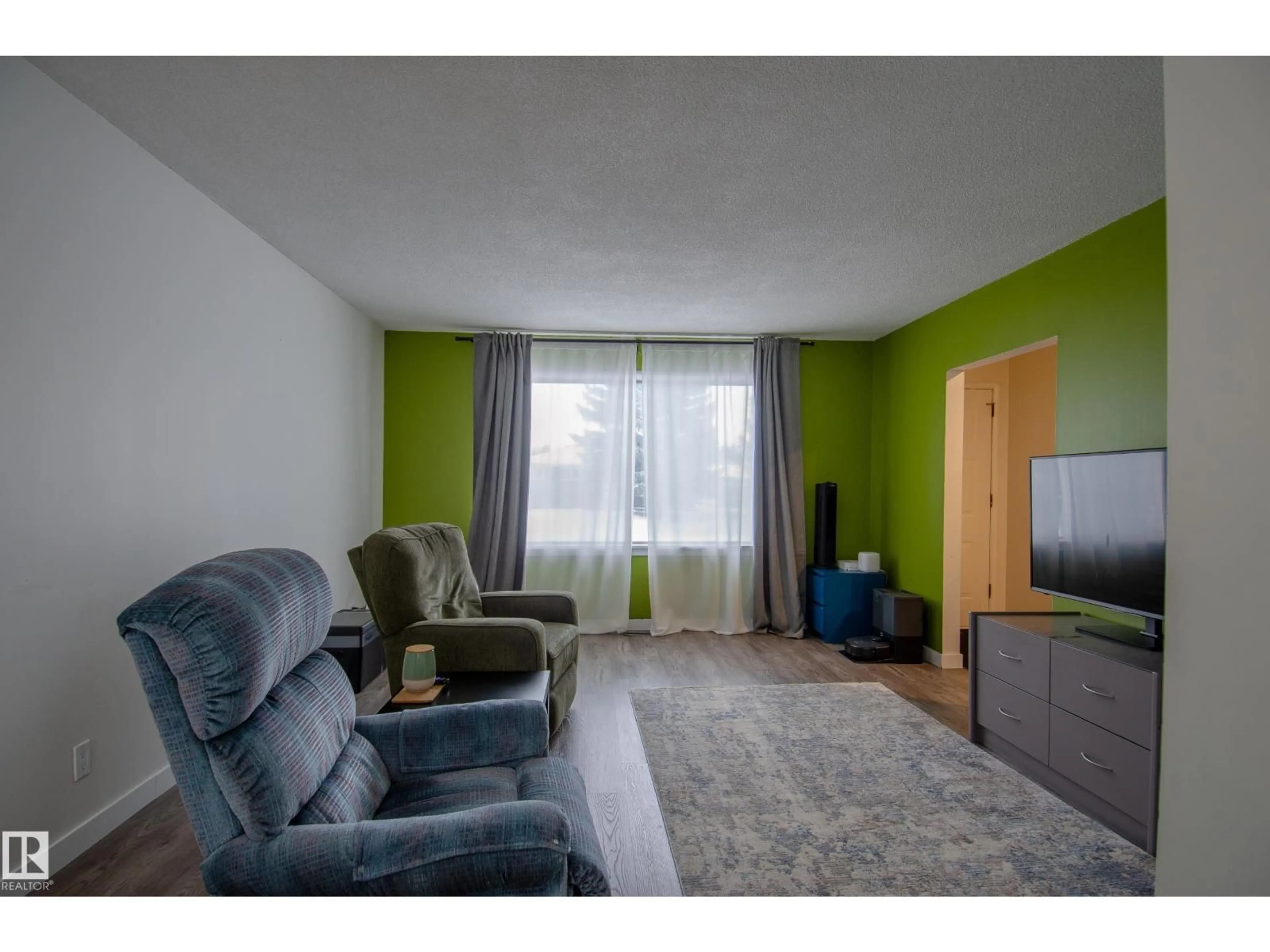 Living room with furniture, wood/laminate floor for 12904 90 ST, Edmonton Alberta T5E3L8