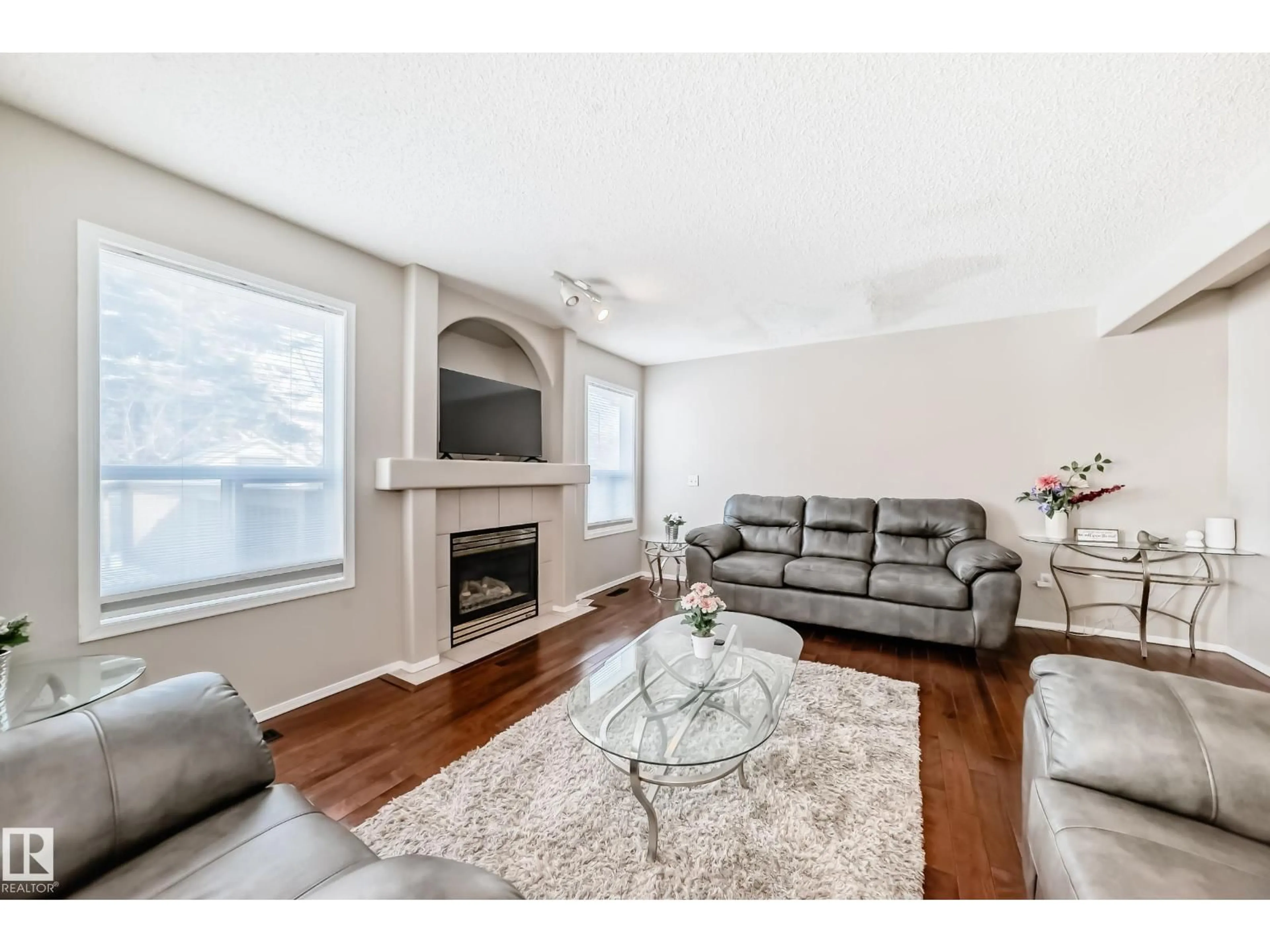 Living room with furniture, wood/laminate floor for 19024 50 AV, Edmonton Alberta T6M2T7