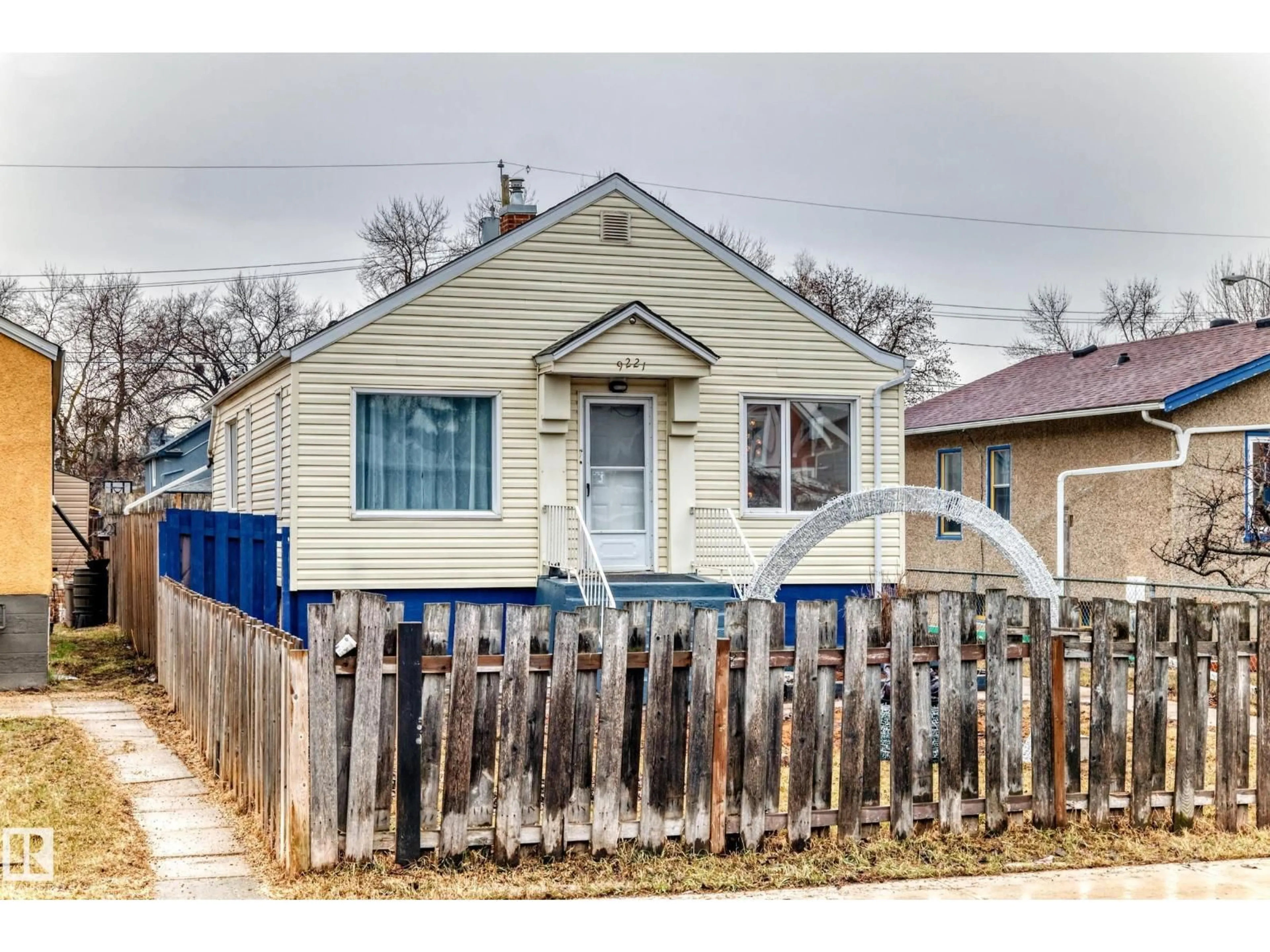 Home with vinyl exterior material, street for 9221 110 AV, Edmonton Alberta T5H1H2