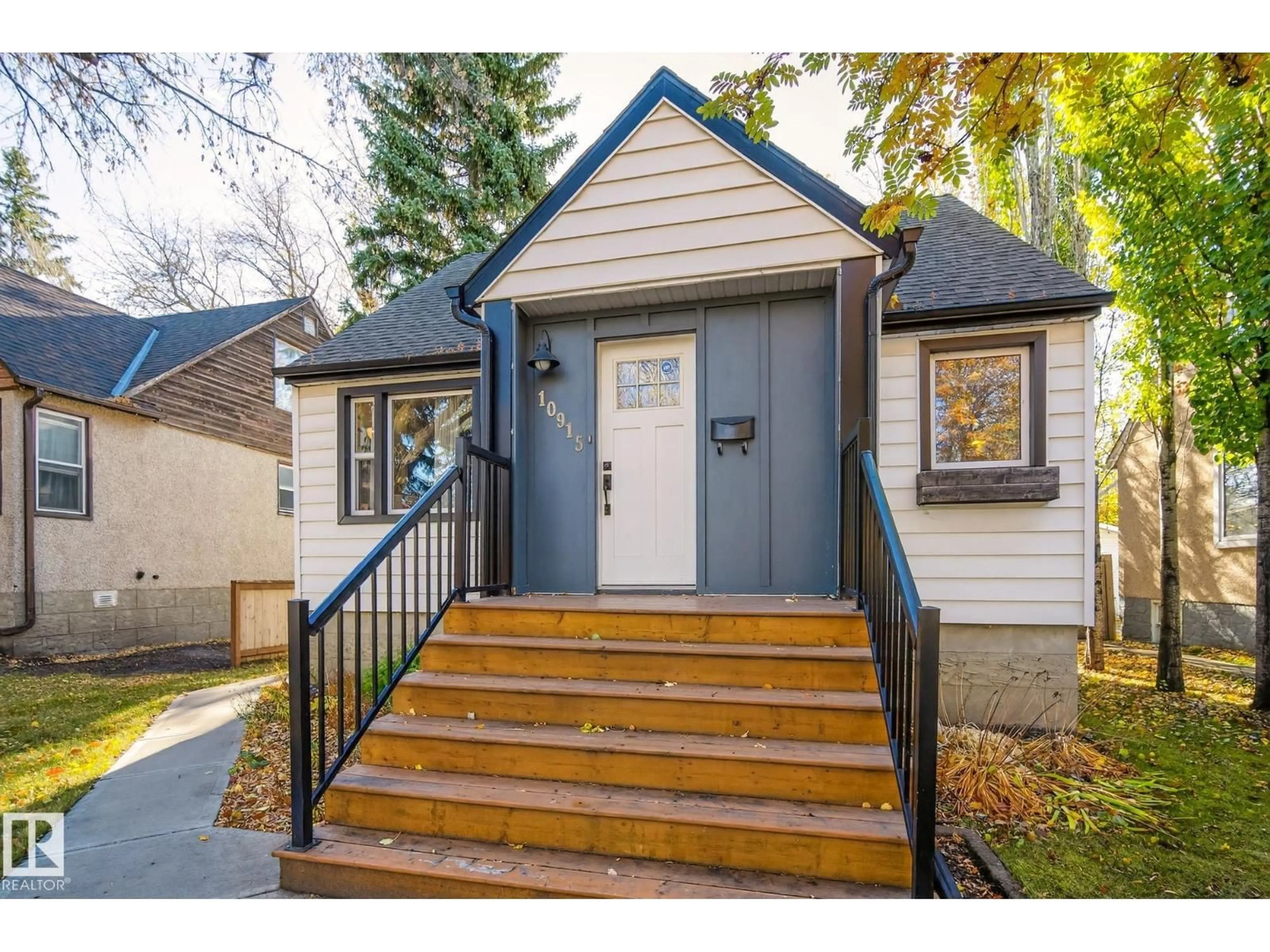 Home with vinyl exterior material, street for 10915 67 AV, Edmonton Alberta T6H2A5