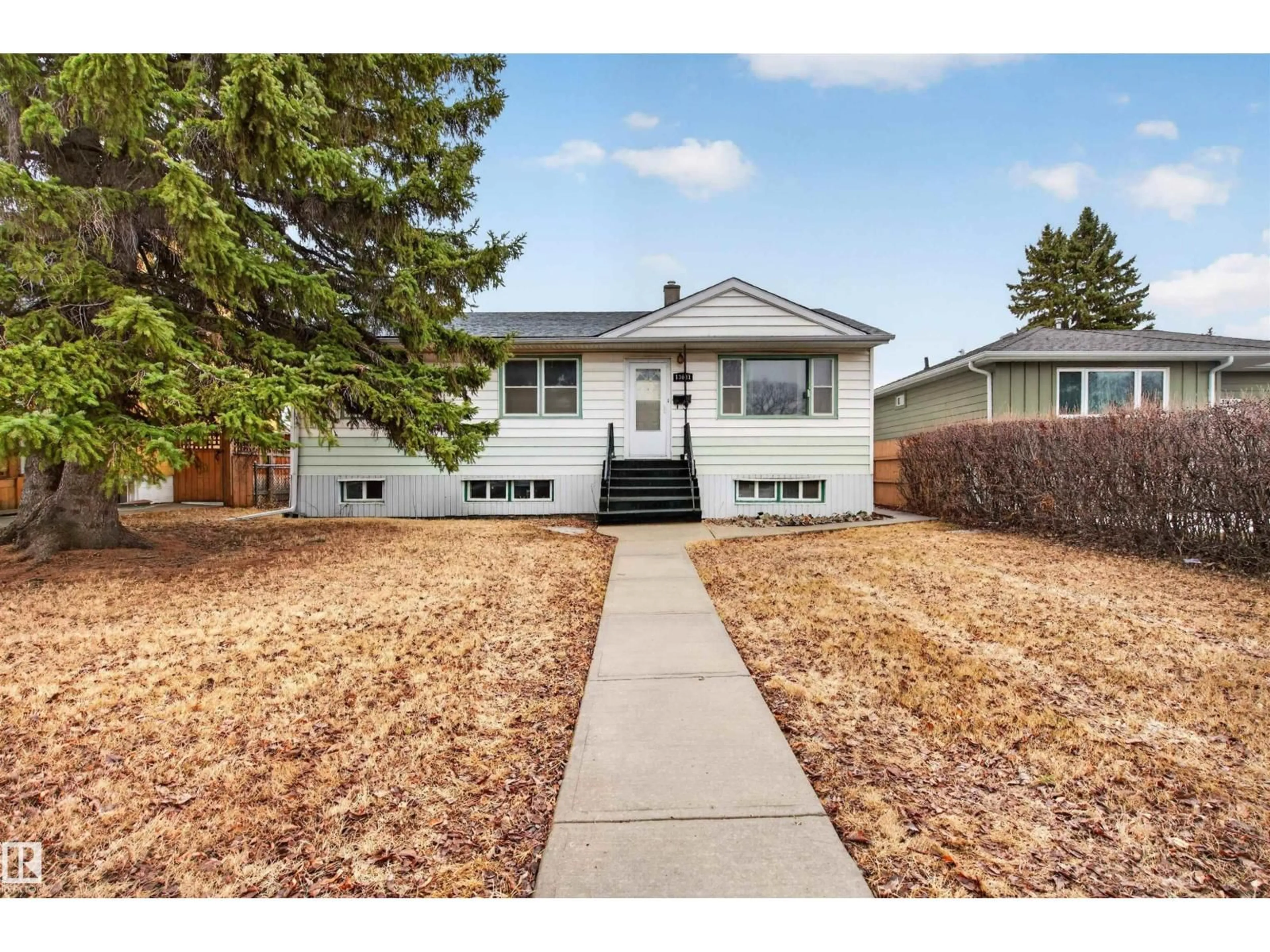 Home with vinyl exterior material, street for 13631 119 AV, Edmonton Alberta T5L2N5