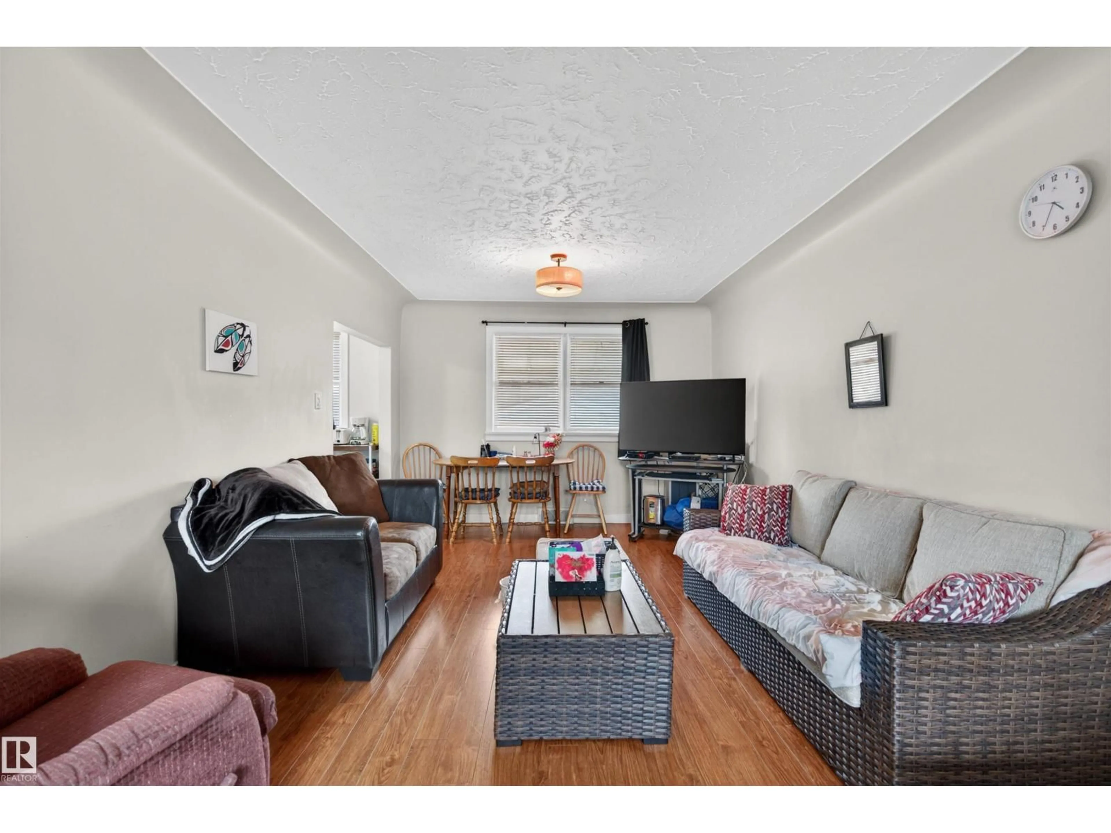 Living room with furniture, wood/laminate floor for 13631 119 AV, Edmonton Alberta T5L2N5