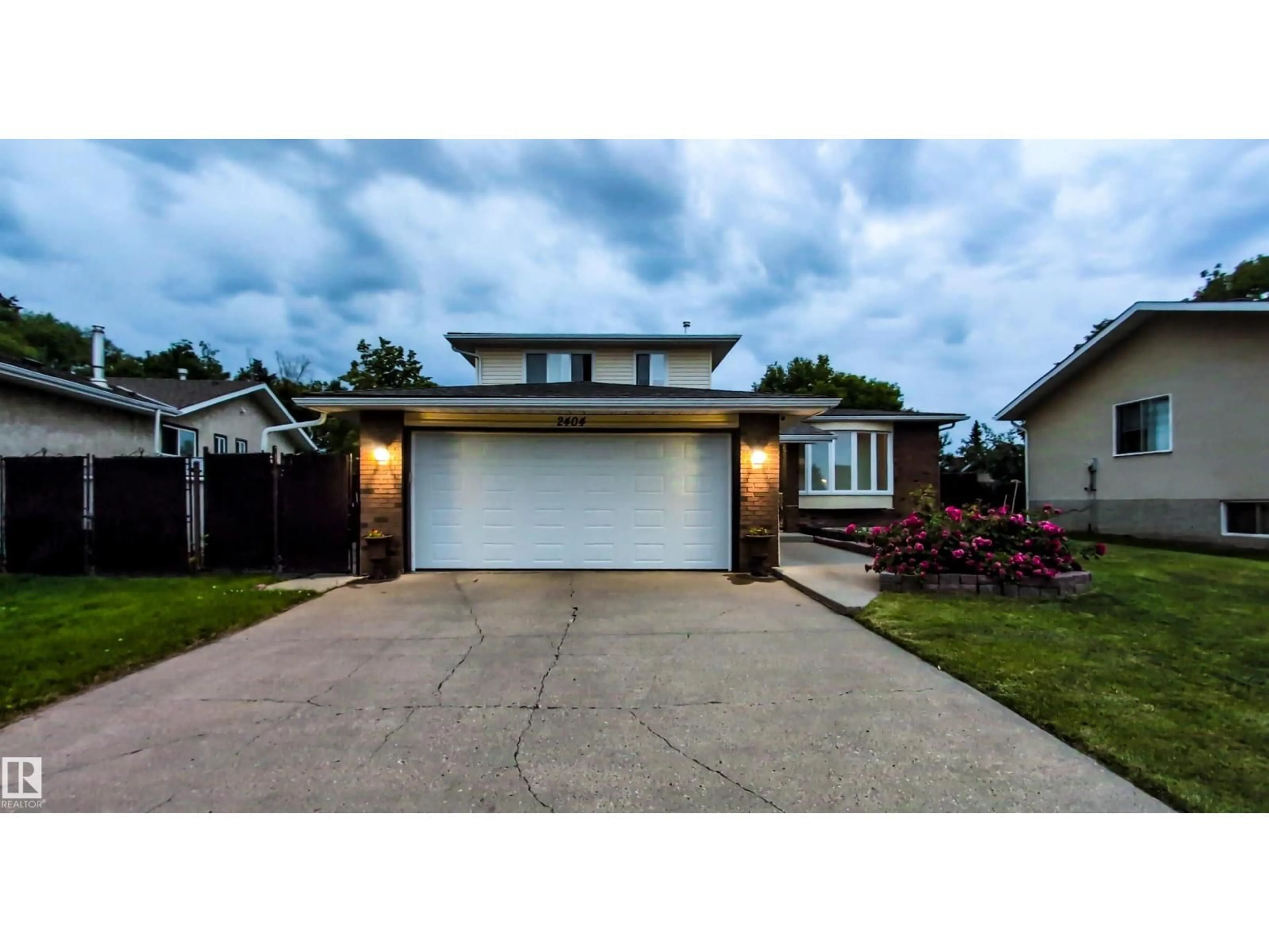 Home with vinyl exterior material, street for NW - 2404 80 ST, Edmonton Alberta T6K3P6