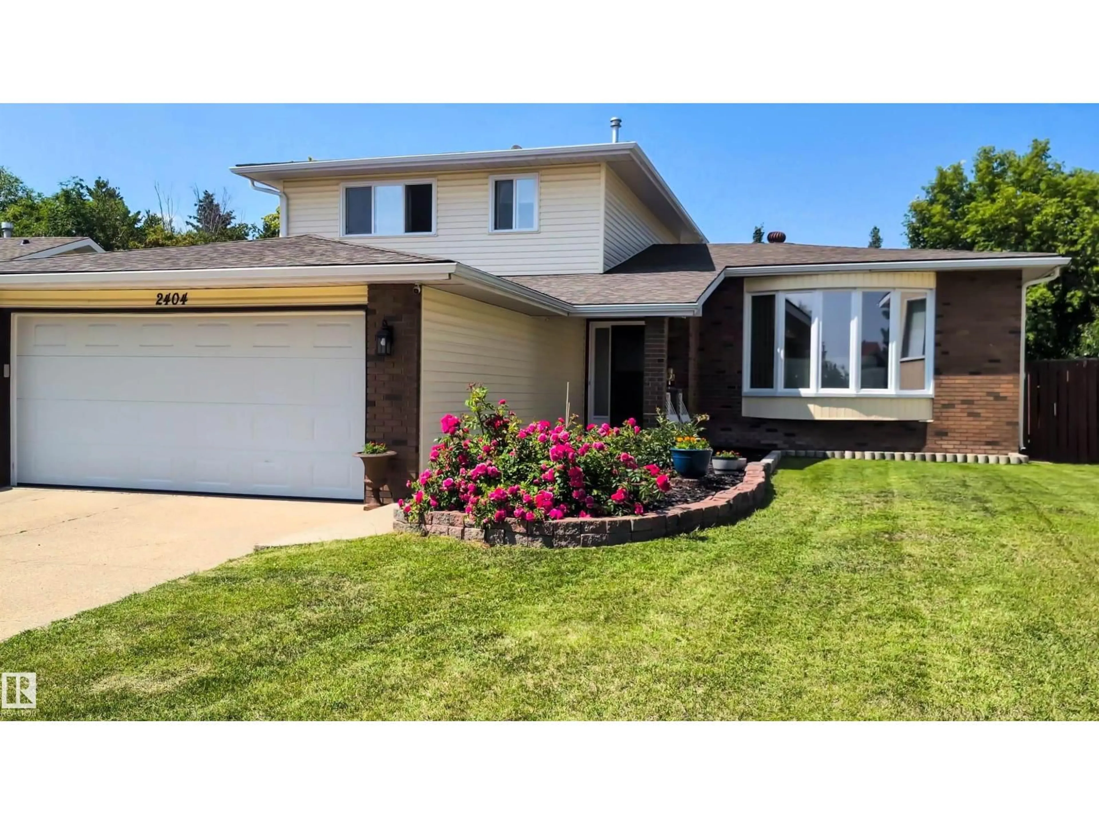 Home with vinyl exterior material, street for NW - 2404 80 ST, Edmonton Alberta T6K3P6