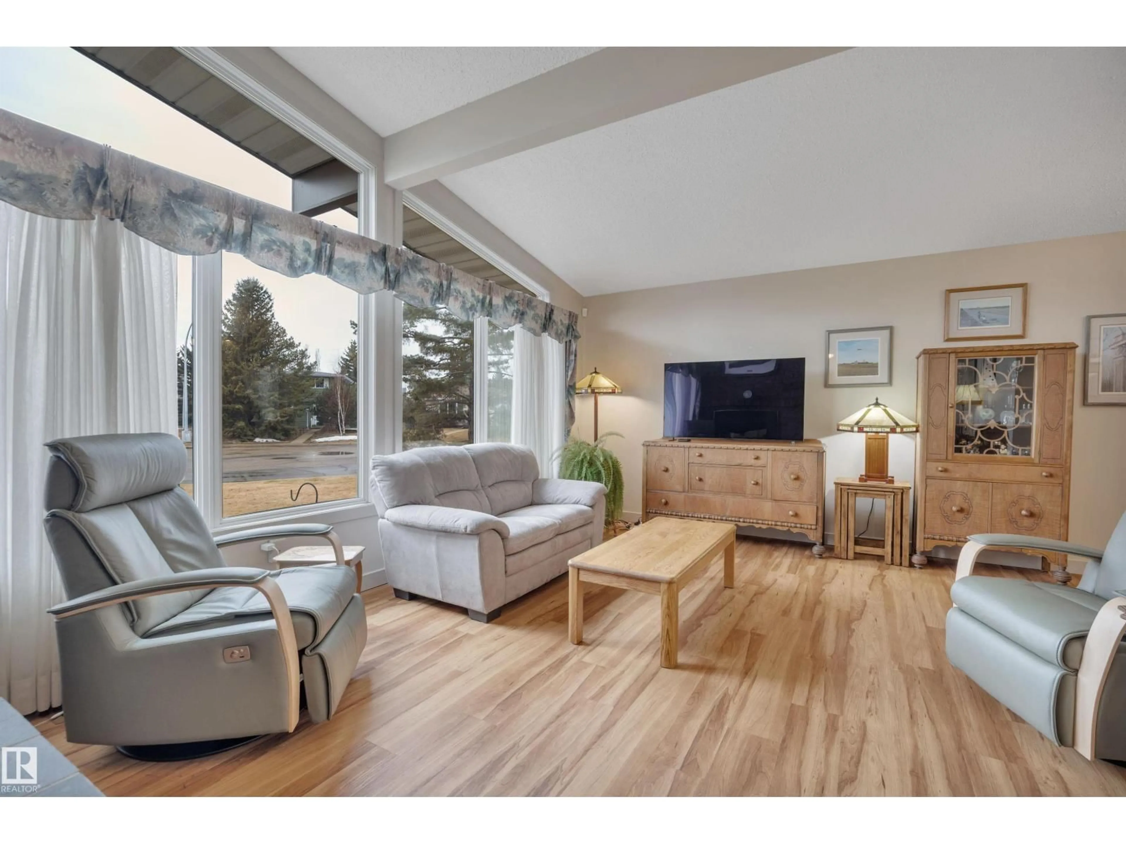 Living room with furniture, wood/laminate floor for 8649 27 AV, Edmonton Alberta T6K2X3