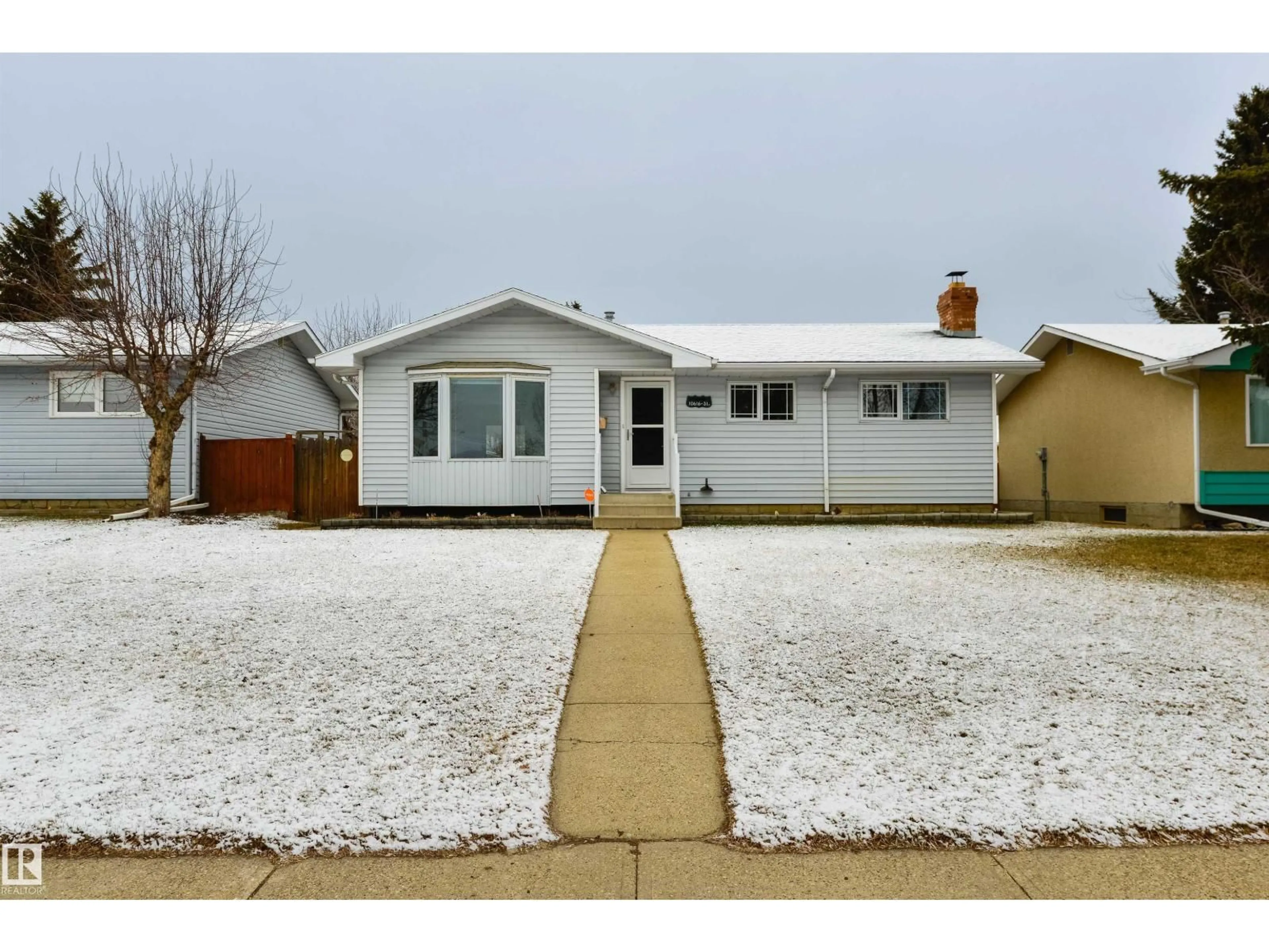 Home with vinyl exterior material, street for 10616 31 ST, Edmonton Alberta T5W1W5