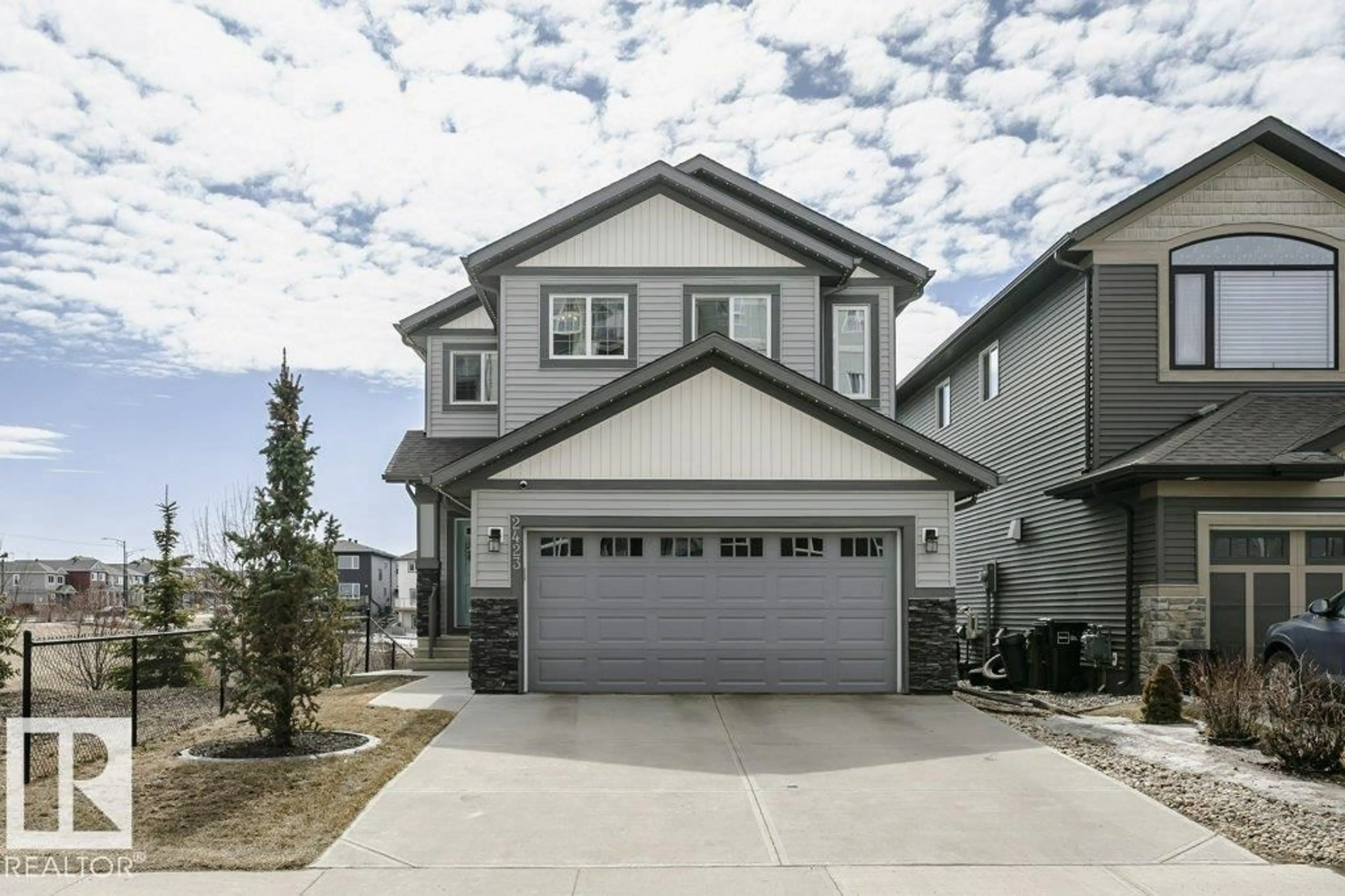 Home with vinyl exterior material, street for 2423 16 AV, Edmonton Alberta T6T2H5