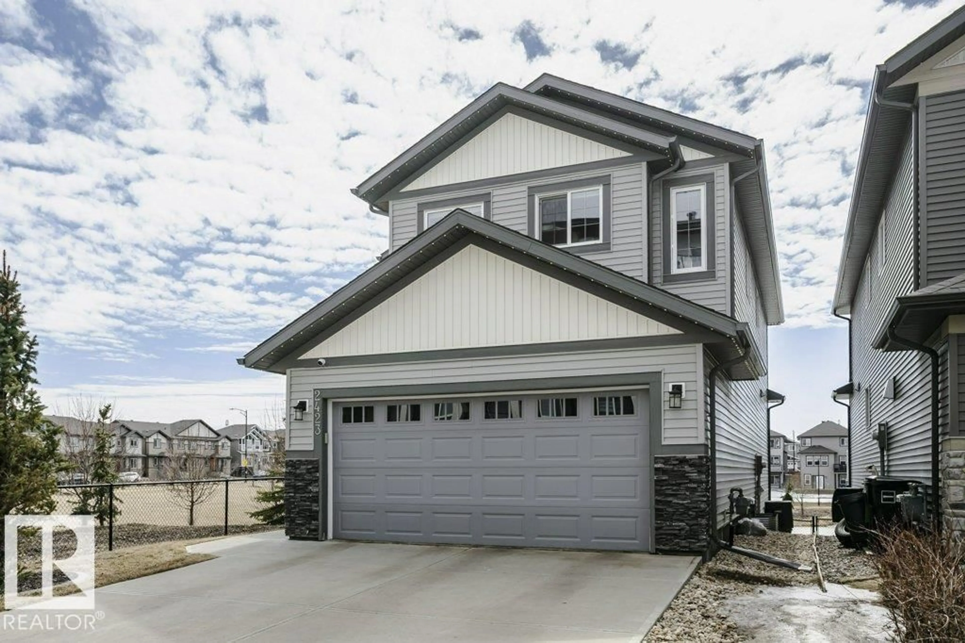 Home with vinyl exterior material, street for 2423 16 AV, Edmonton Alberta T6T2H5