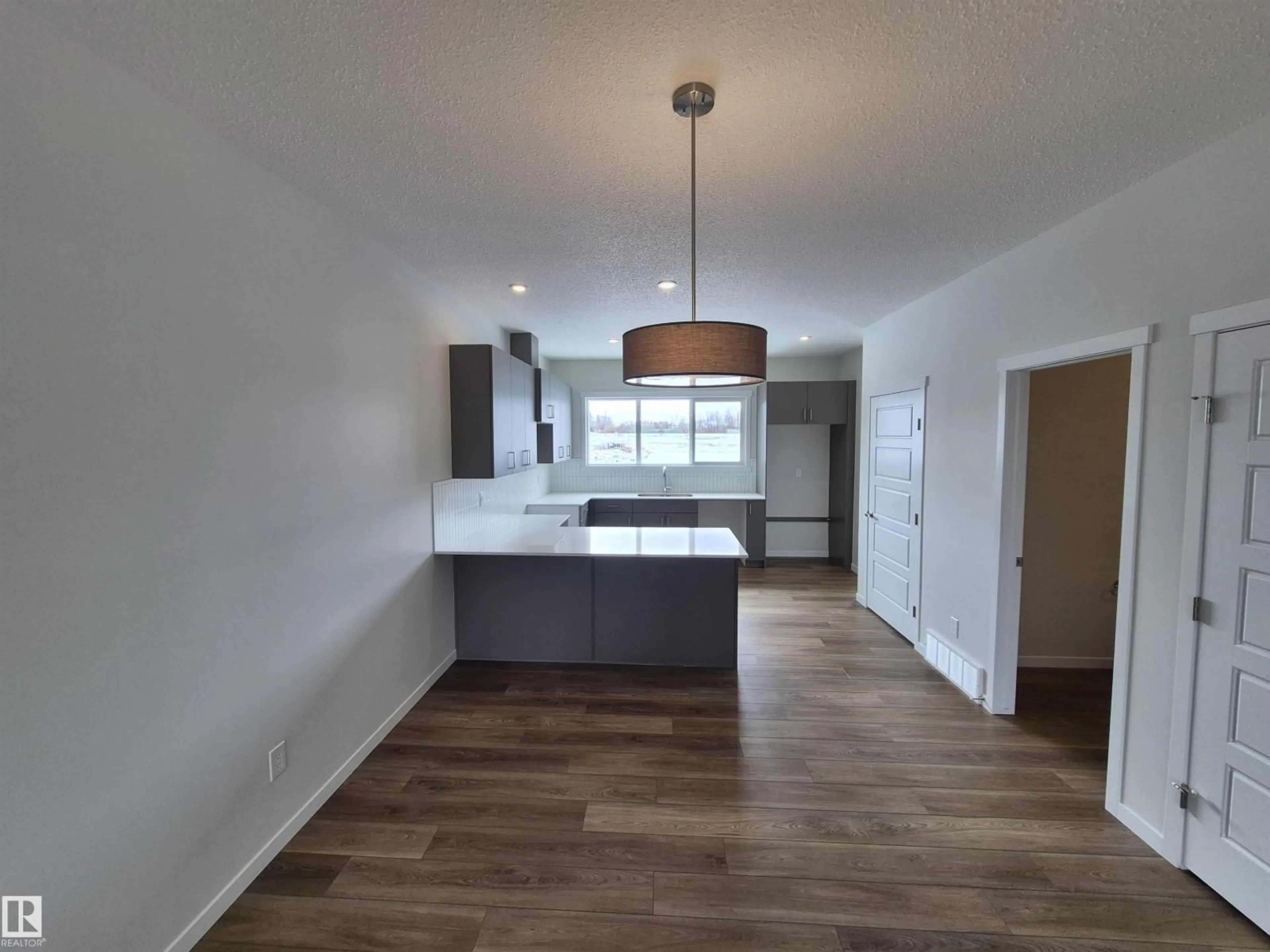 Open concept kitchen, wood/laminate floor for 1088 MCLEOD AV, Spruce Grove Alberta T7X4G8