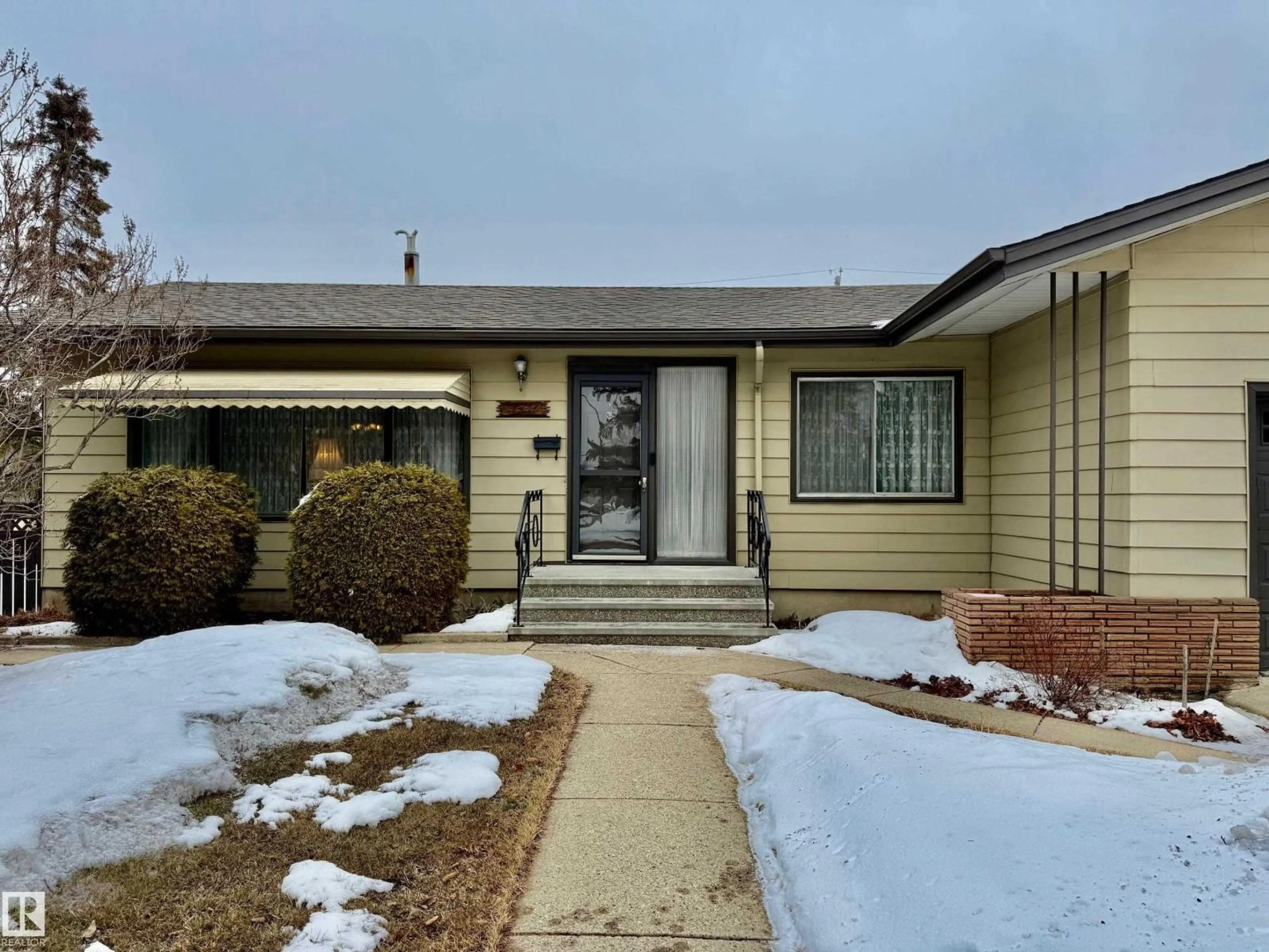 Home with vinyl exterior material, street for 13515 129 ST, Edmonton Alberta T5L1K4