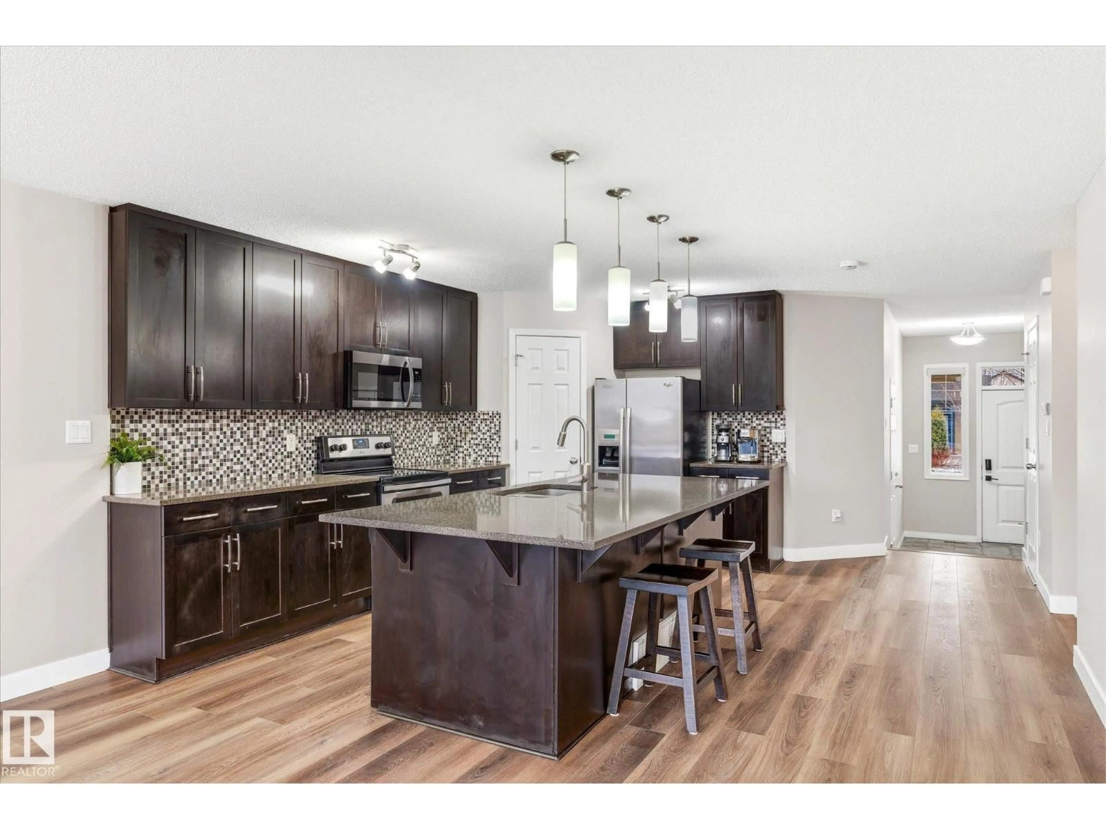 Open concept kitchen, wood/laminate floor for 1668 CHAPMAN WY, Edmonton Alberta T6W0Y5
