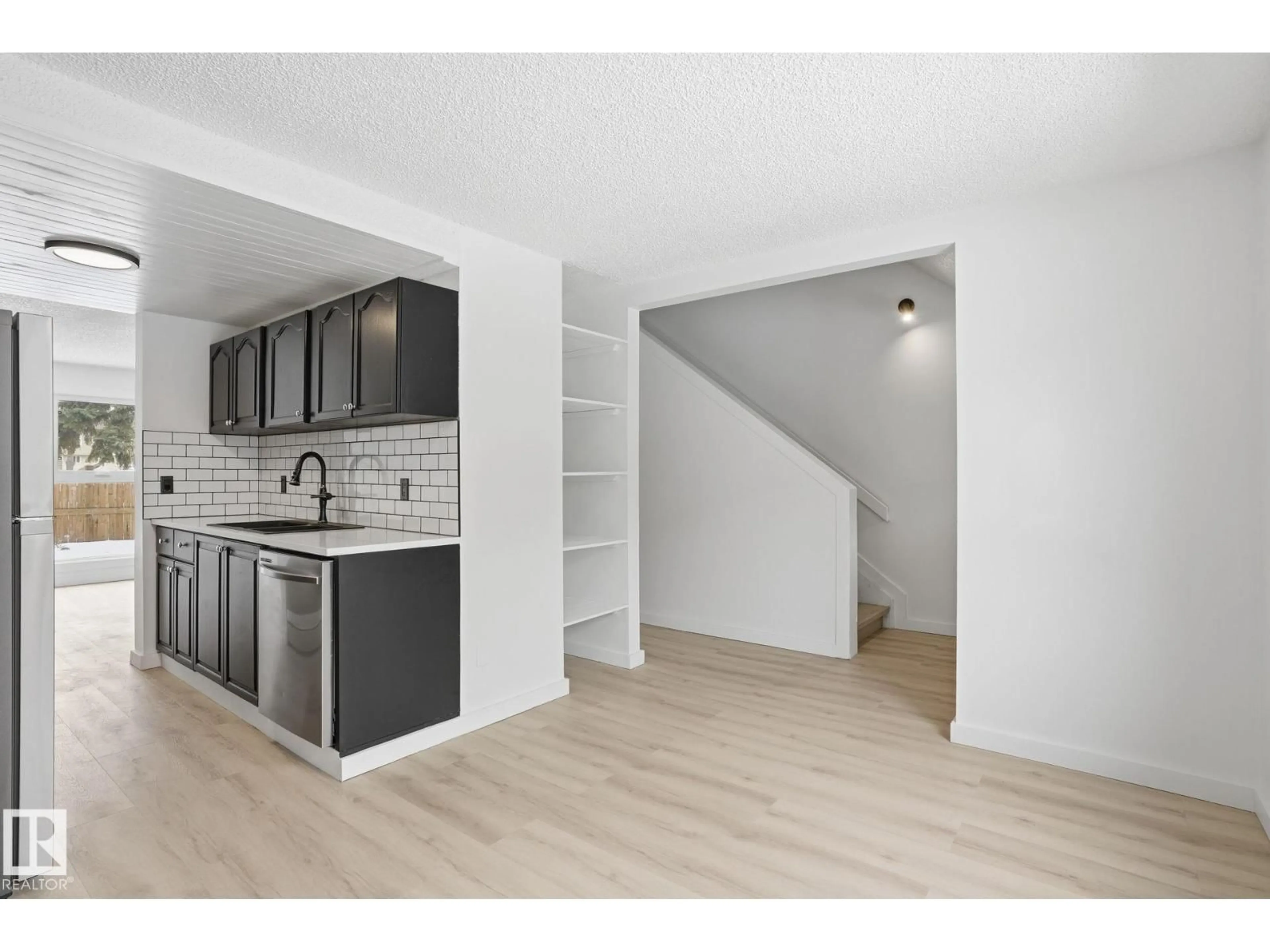 Open concept kitchen, wood/laminate floor for 260 - 3307 116A AV, Edmonton Alberta T5W5J9