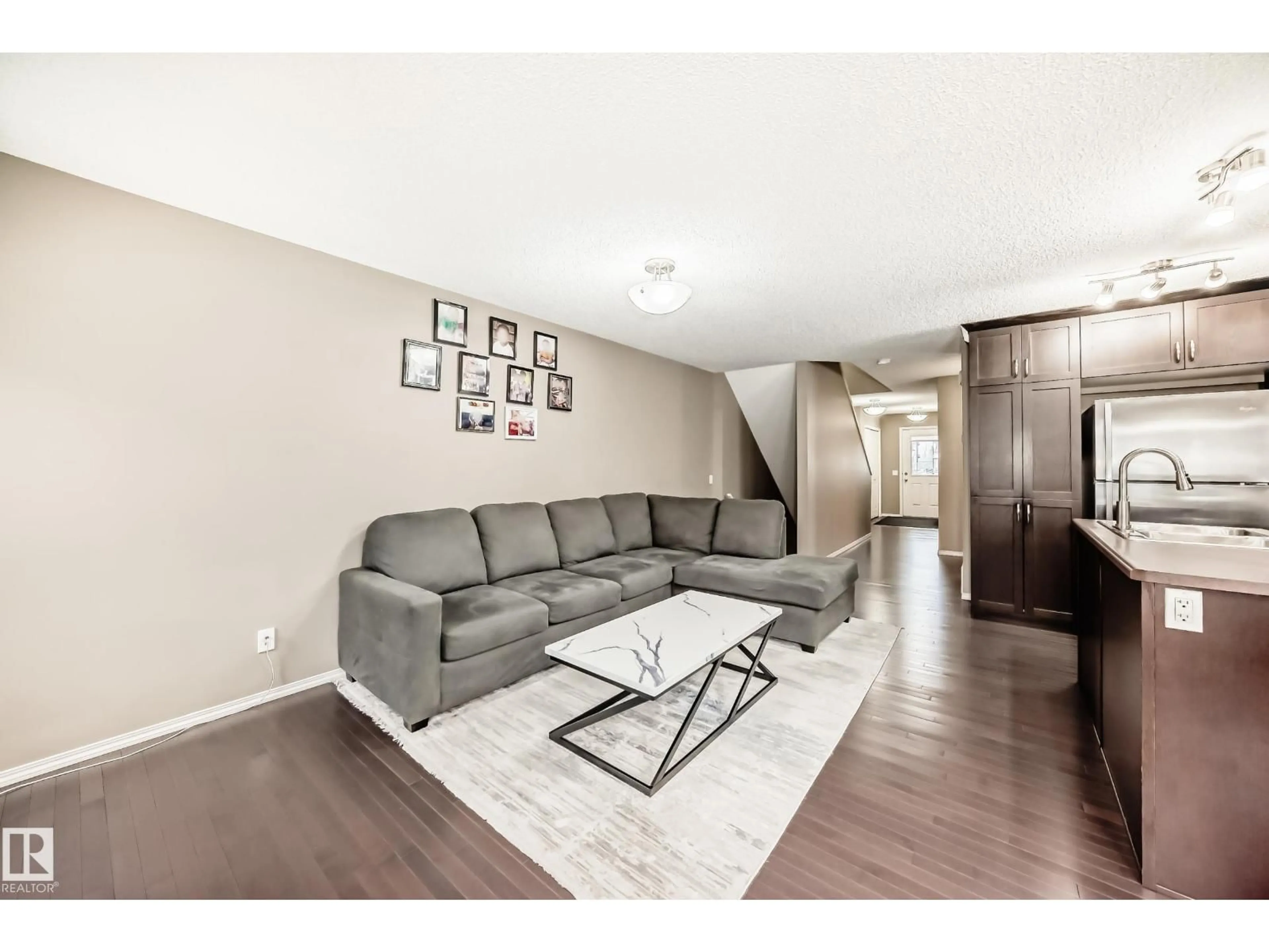 Living room with furniture, wood/laminate floor for 8 - 13838 166AVE NW, Edmonton Alberta T6V0K3