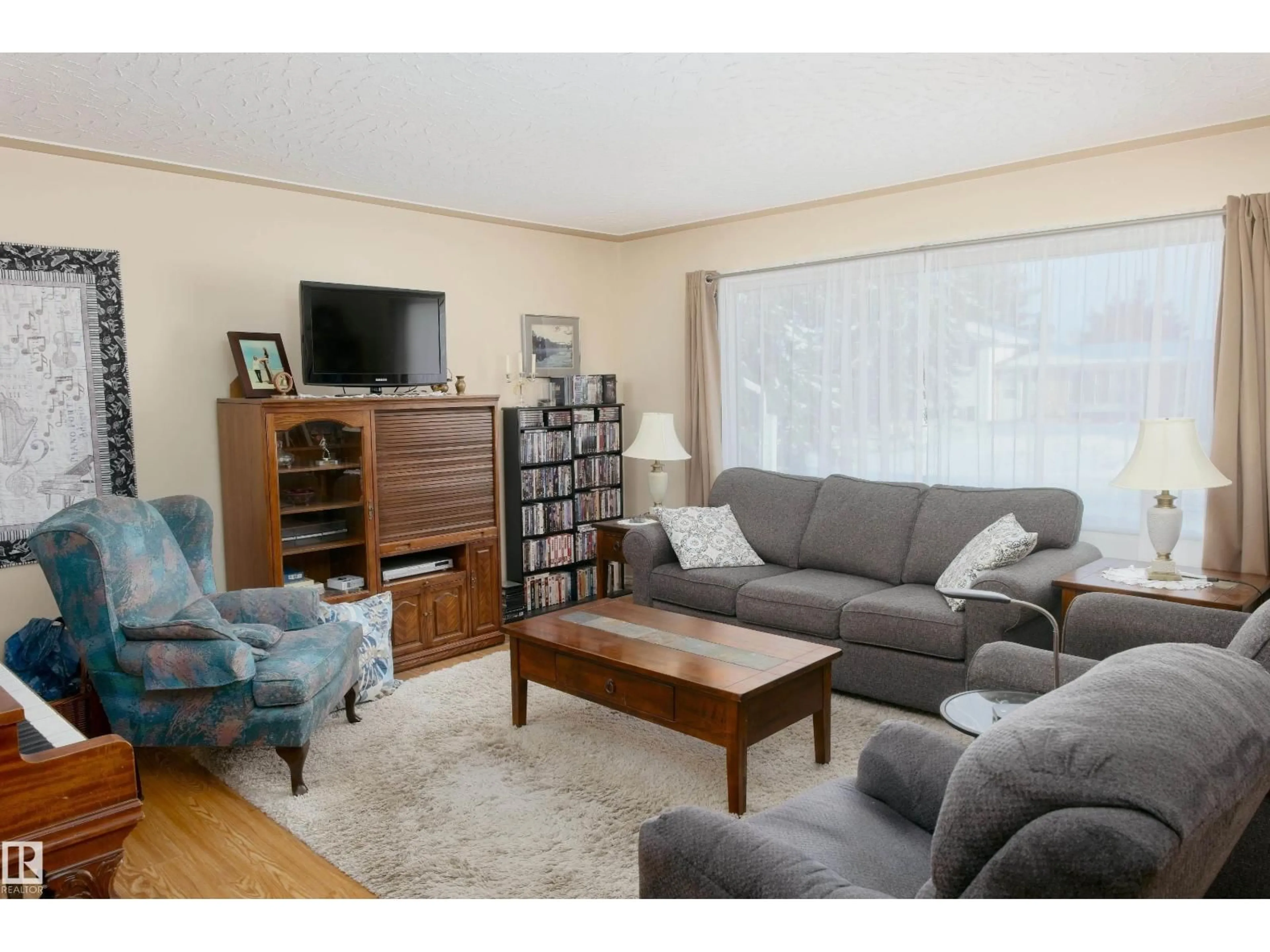 Living room with furniture, wood/laminate floor for 4421 57 AV, Barrhead Alberta T7N1C2