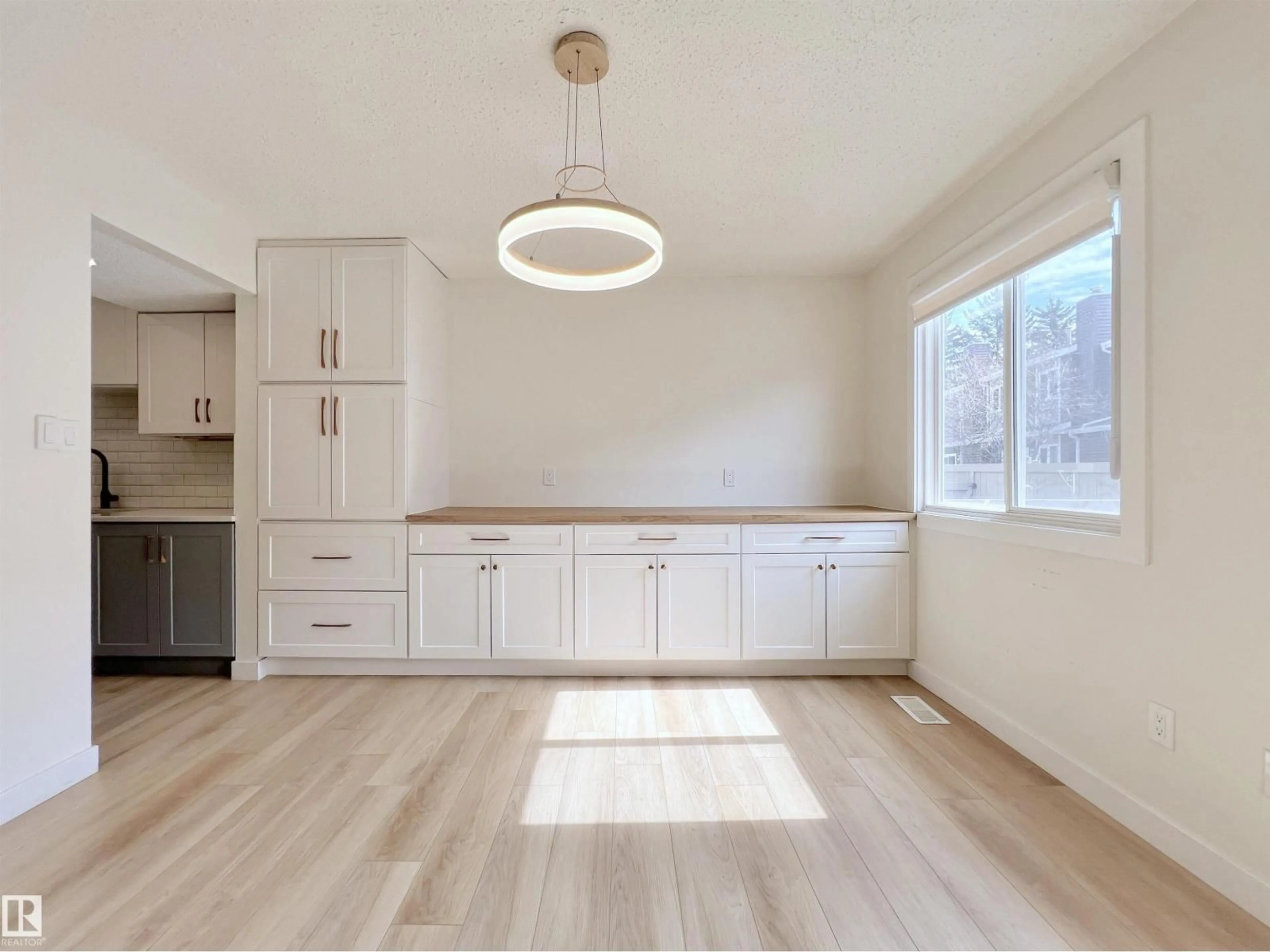 Open concept kitchen, wood/laminate floor for #12 - 3221 119 ST, Edmonton Alberta T6J5K7