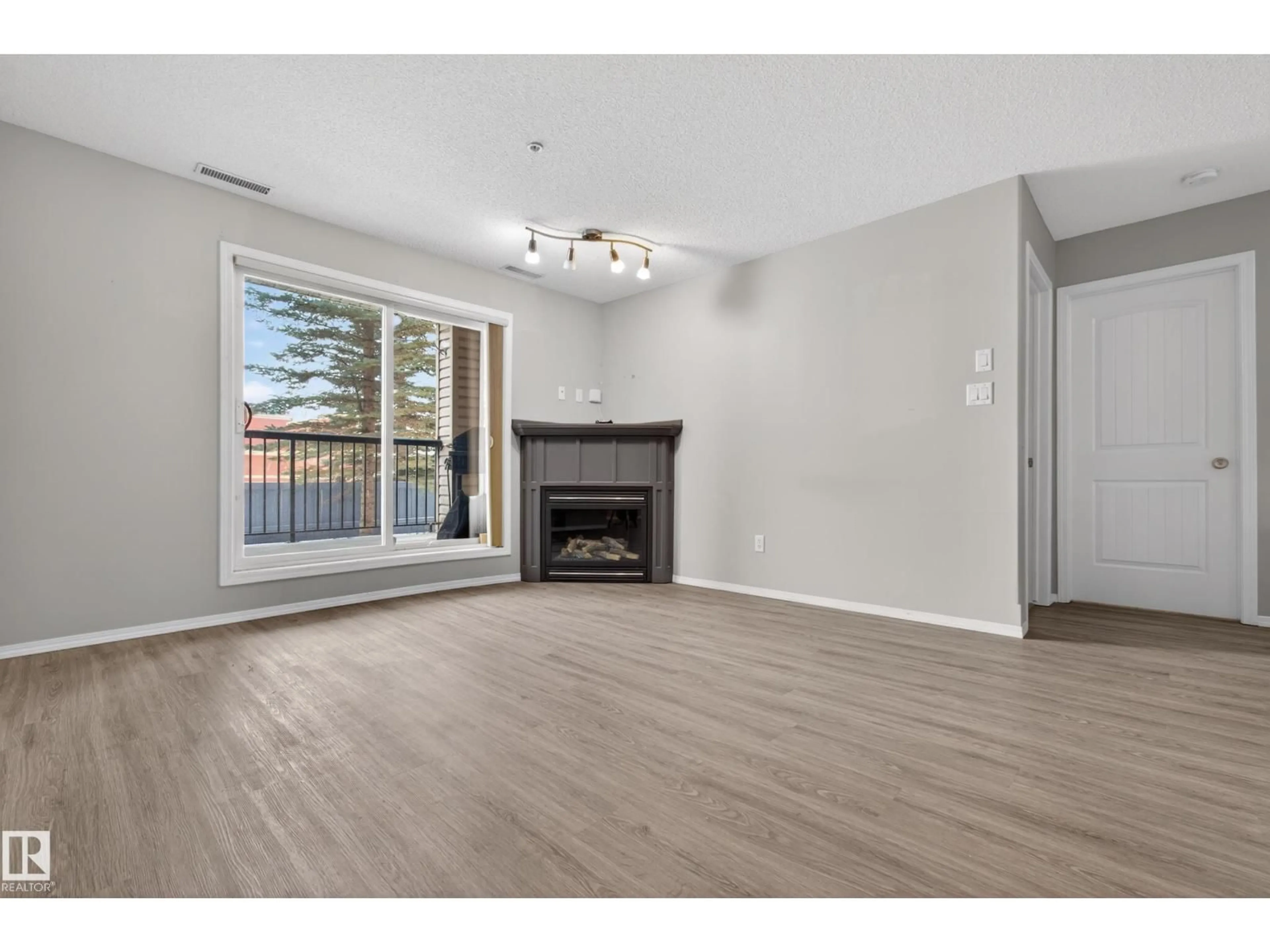 Living room with furniture, wood/laminate floor for 2098 - 131 BLACKMUD CREEK DR, Edmonton Alberta T6W1T7