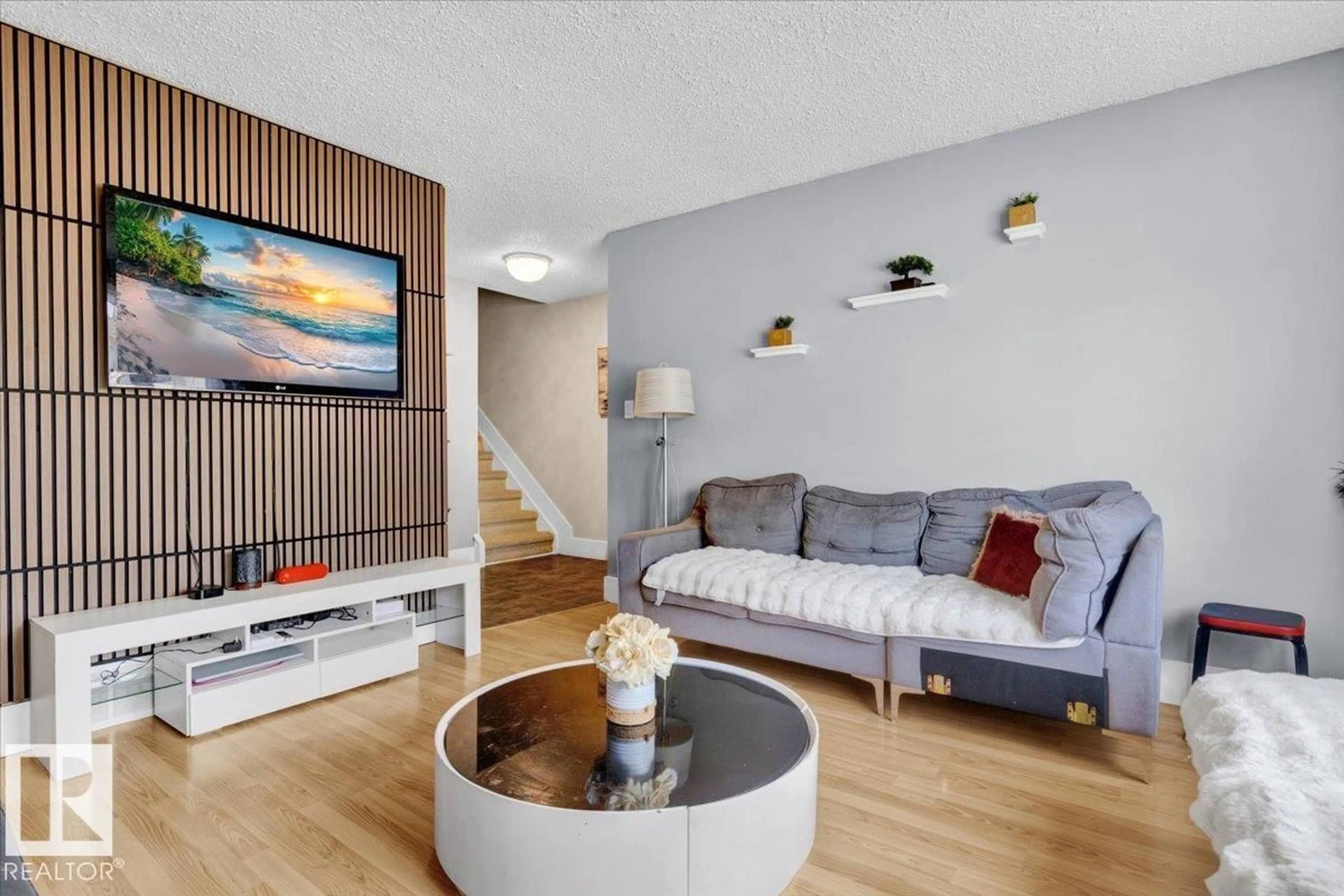 Living room with furniture, wood/laminate floor for 10027 173 AV, Edmonton Alberta T5X3Y1