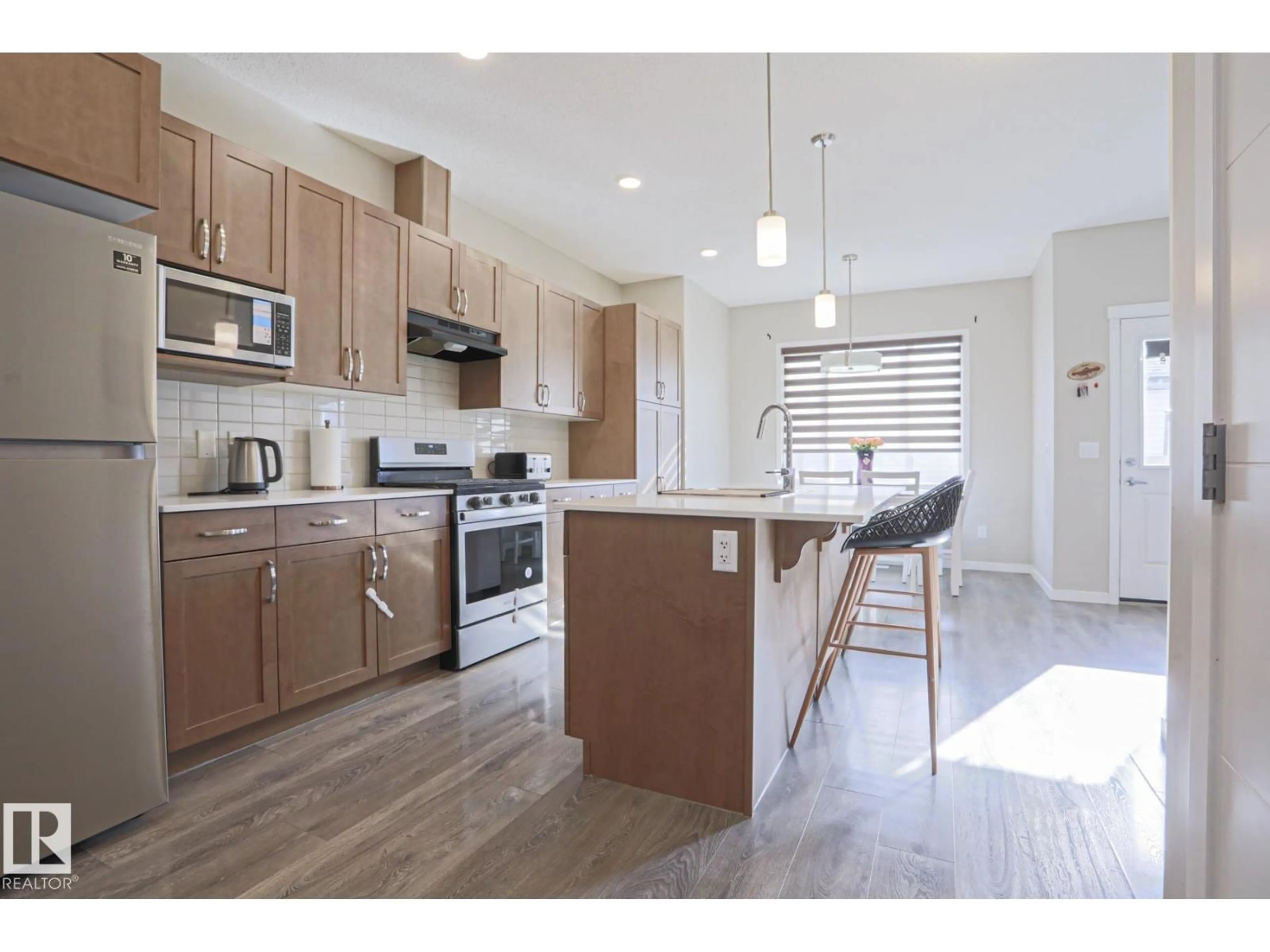 Open concept kitchen, wood/laminate floor for NW - 1505 24 ST, Edmonton Alberta T6T2B9