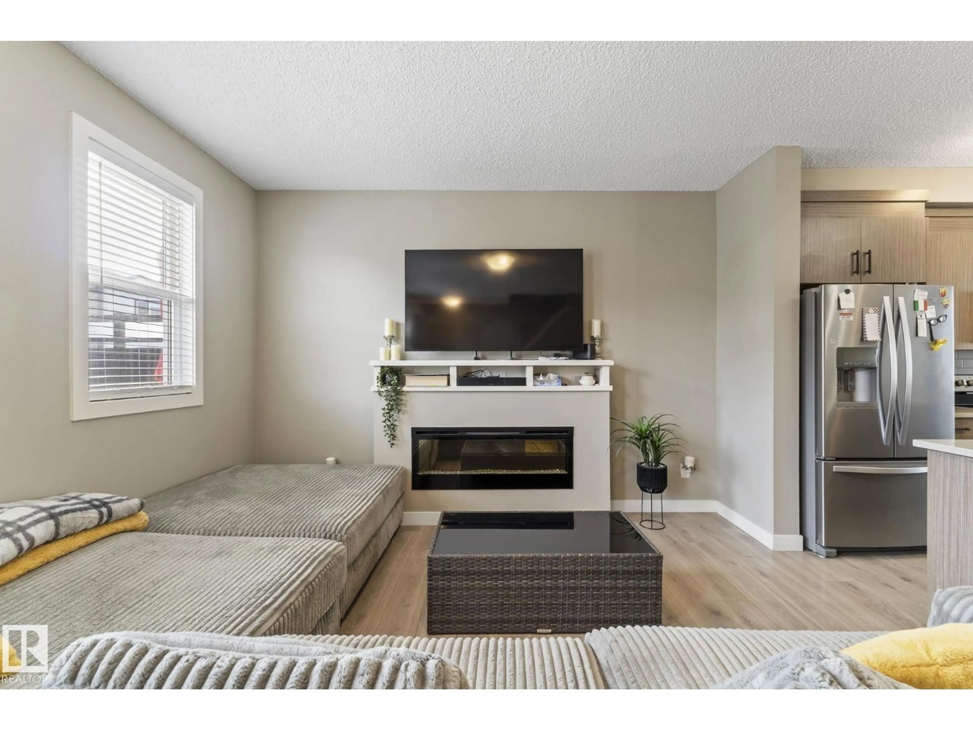 Living room with furniture, wood/laminate floor for NW - 27 16903 68 ST, Edmonton Alberta T5Z0R1