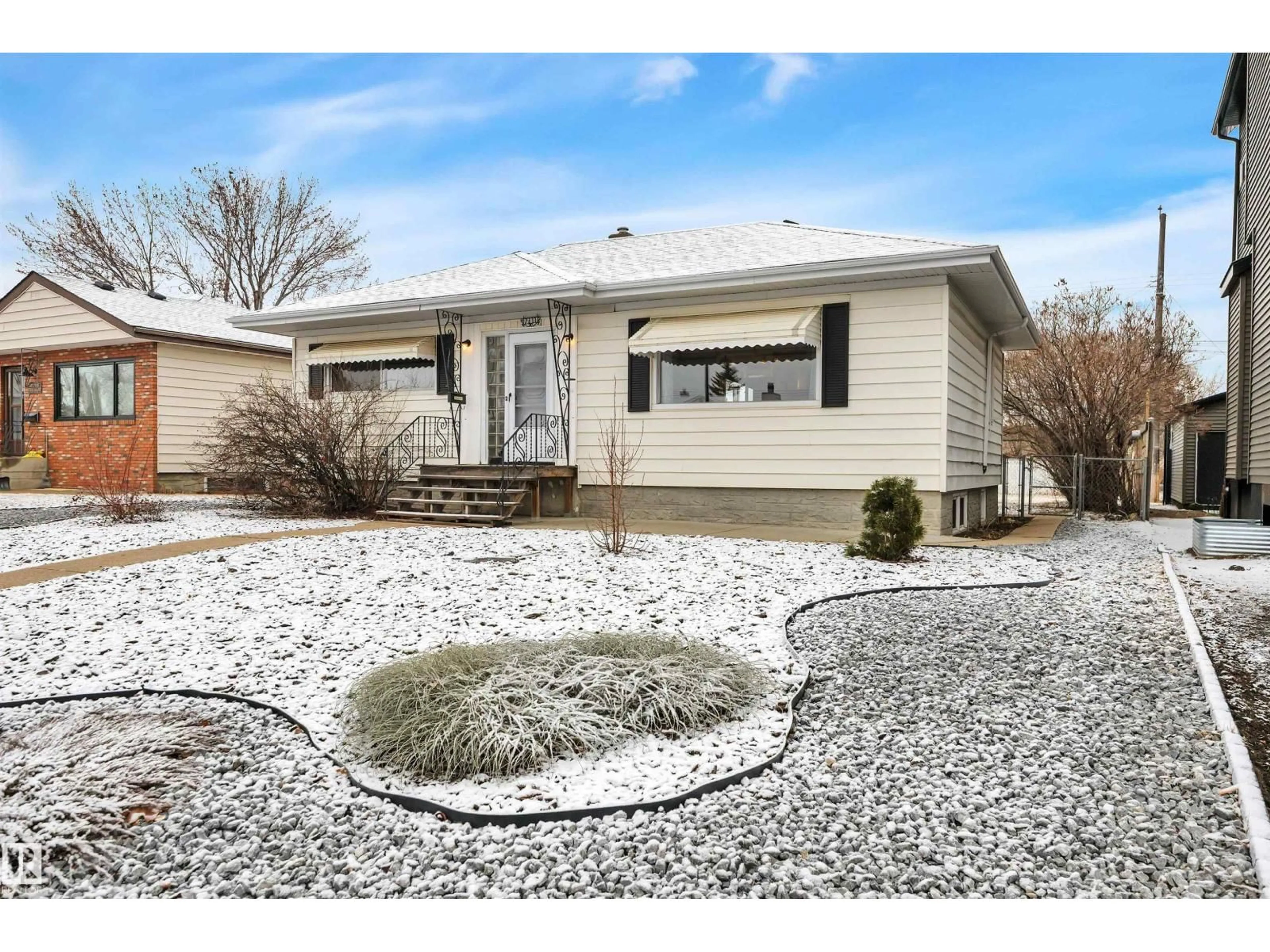 Home with vinyl exterior material, street for 7311 82 ST, Edmonton Alberta T6C2X2