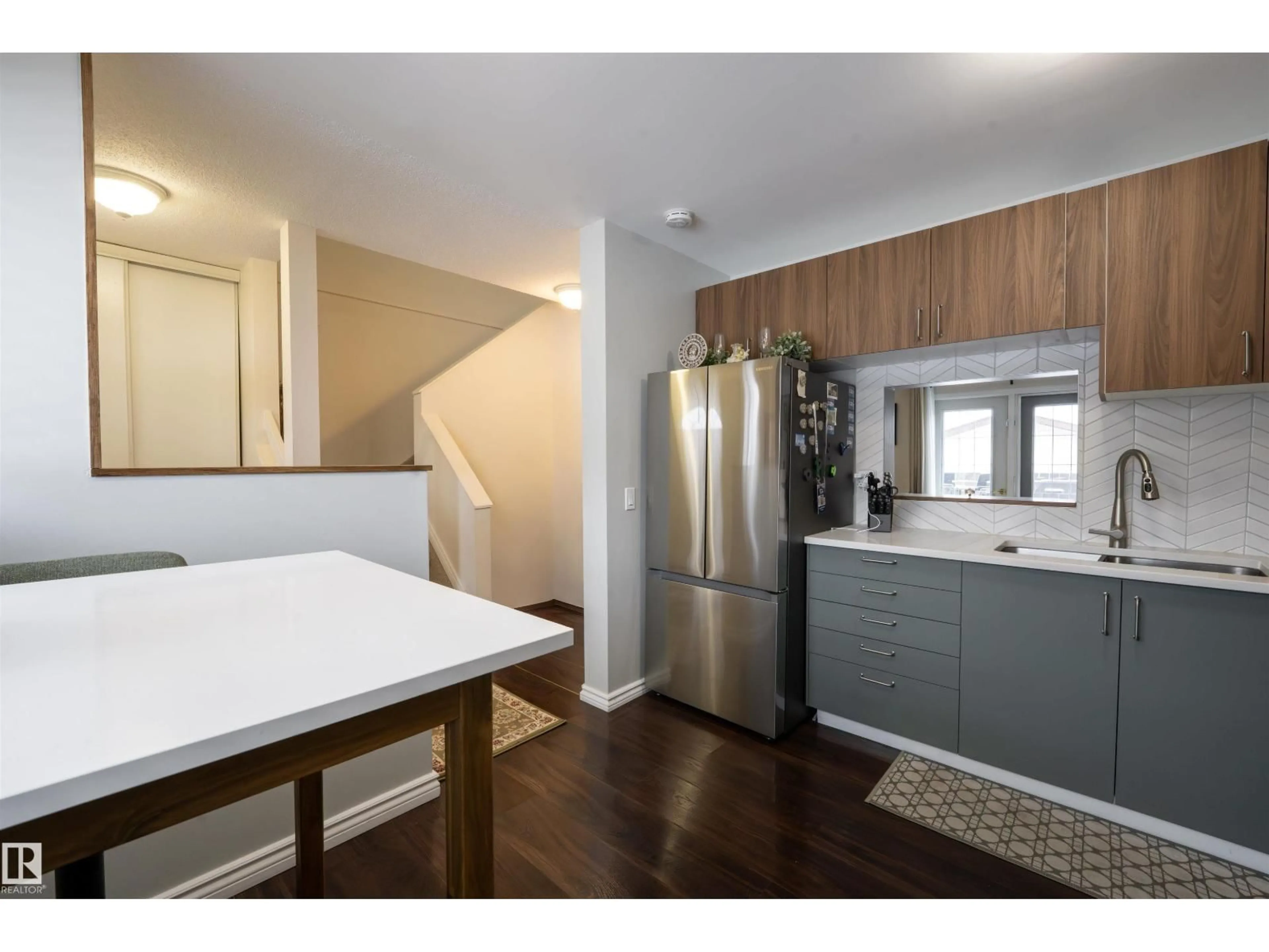 Open concept kitchen, wood/laminate floor for 1728 37 ST, Edmonton Alberta T6L2R7