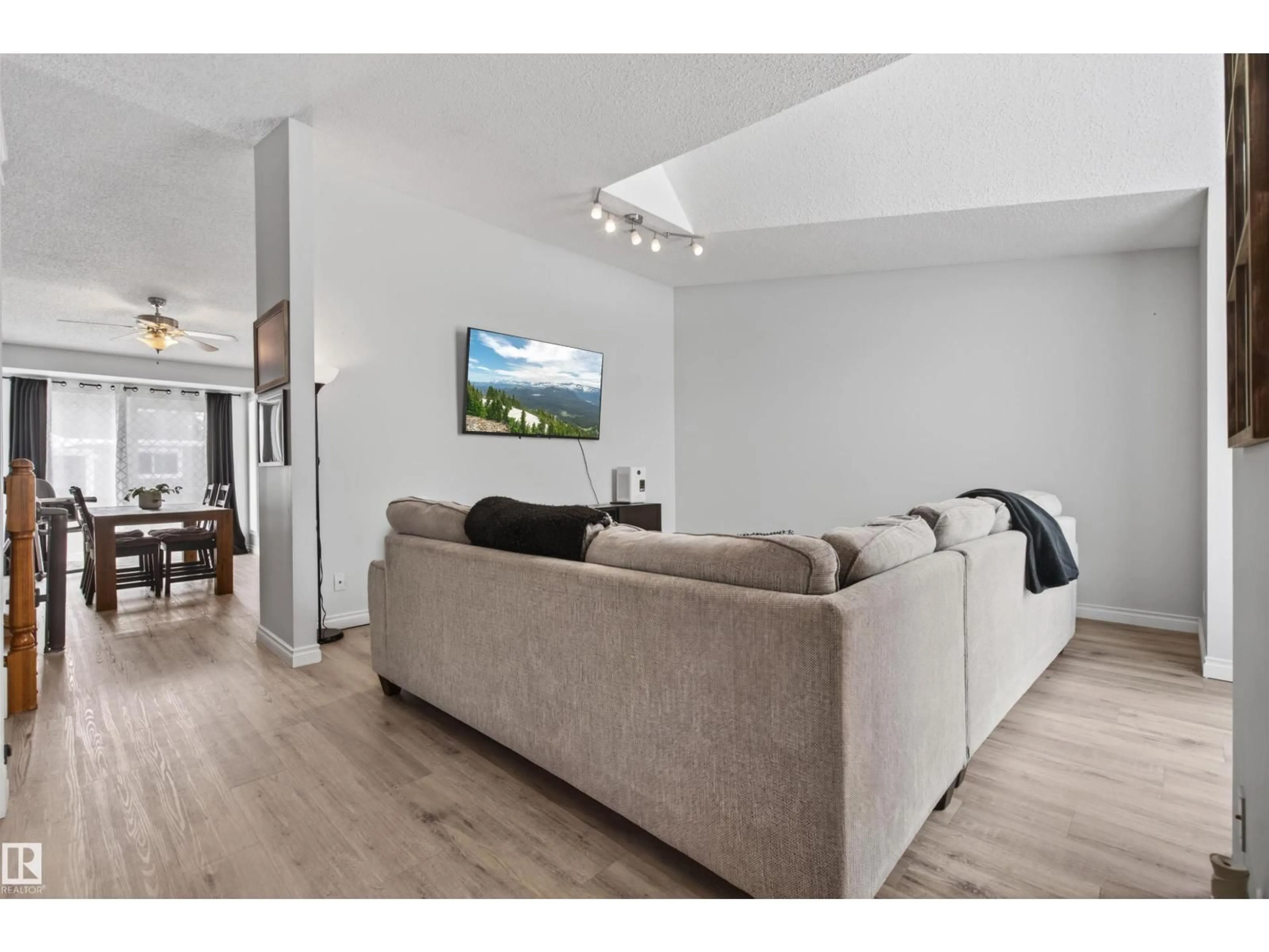 Living room with furniture, wood/laminate floor for 208 20A ST, Cold Lake Alberta T9M1G3