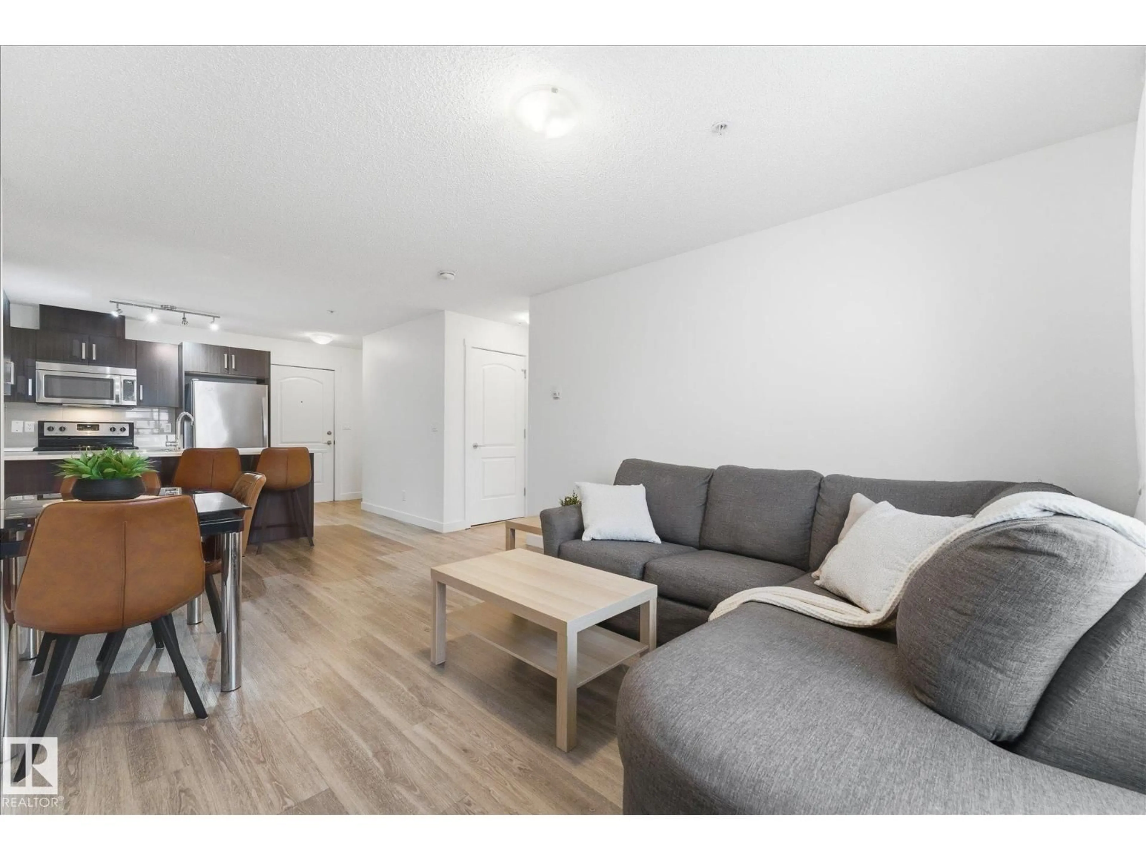 Living room with furniture, wood/laminate floor for 667 - 316 WATT BV, Edmonton Alberta T6X0Y2