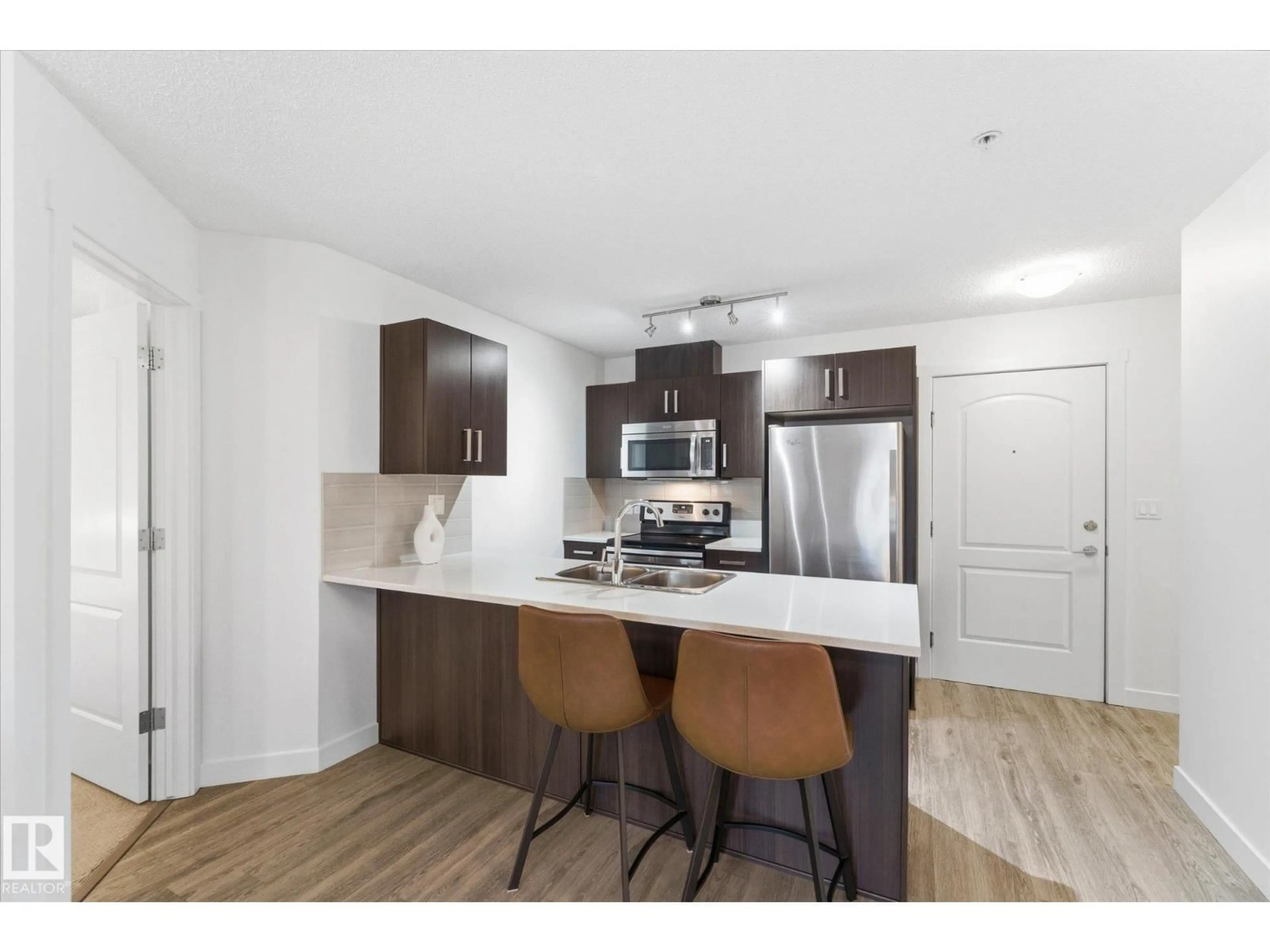 Open concept kitchen, wood/laminate floor for 667 - 316 WATT BV, Edmonton Alberta T6X0Y2