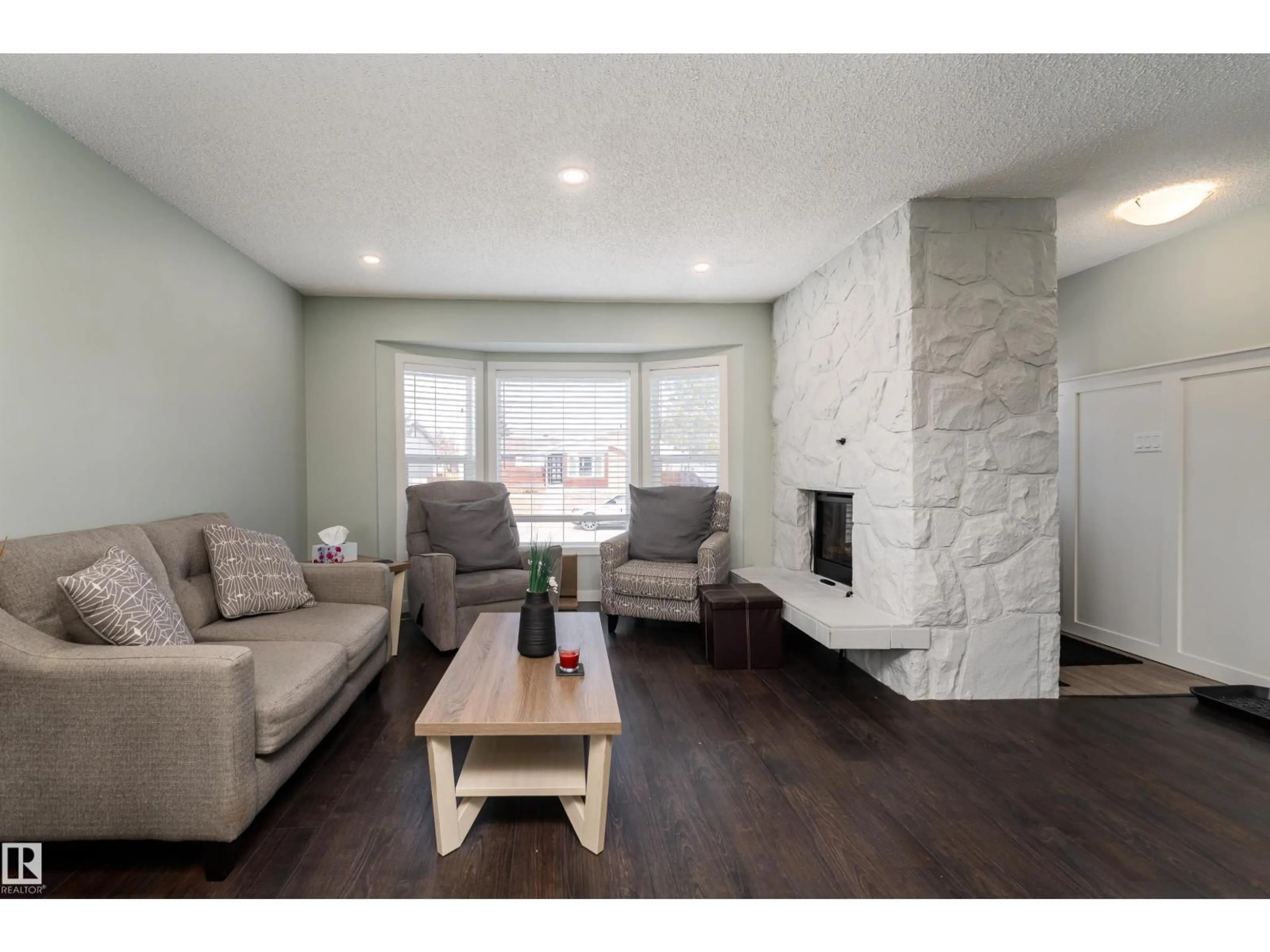 Living room with furniture, wood/laminate floor for 8503 151 AV, Edmonton Alberta T5E5Y1