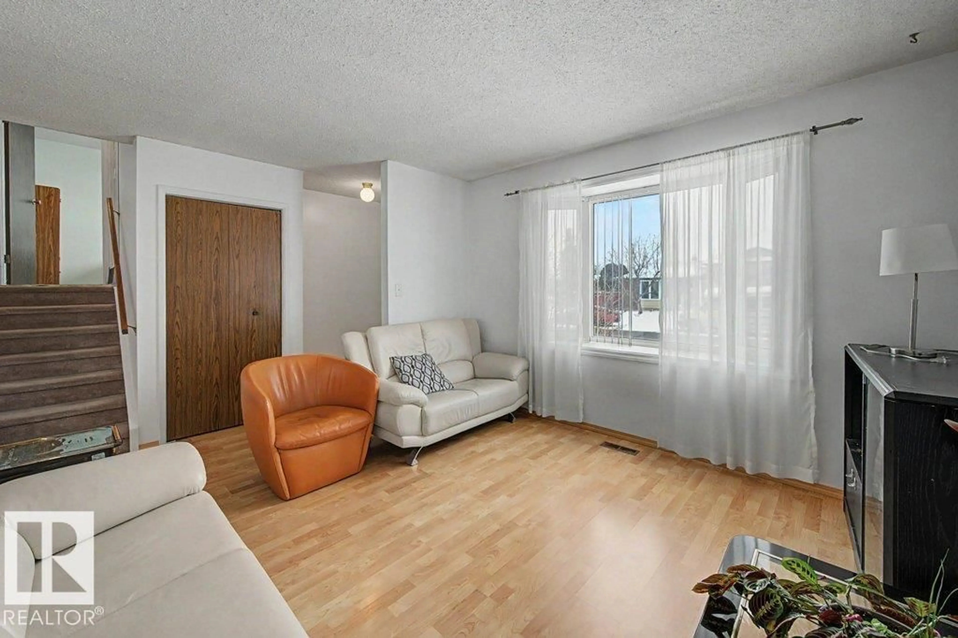 Living room with furniture, wood/laminate floor for 691 WARWICK RD, Edmonton Alberta T5X4R2