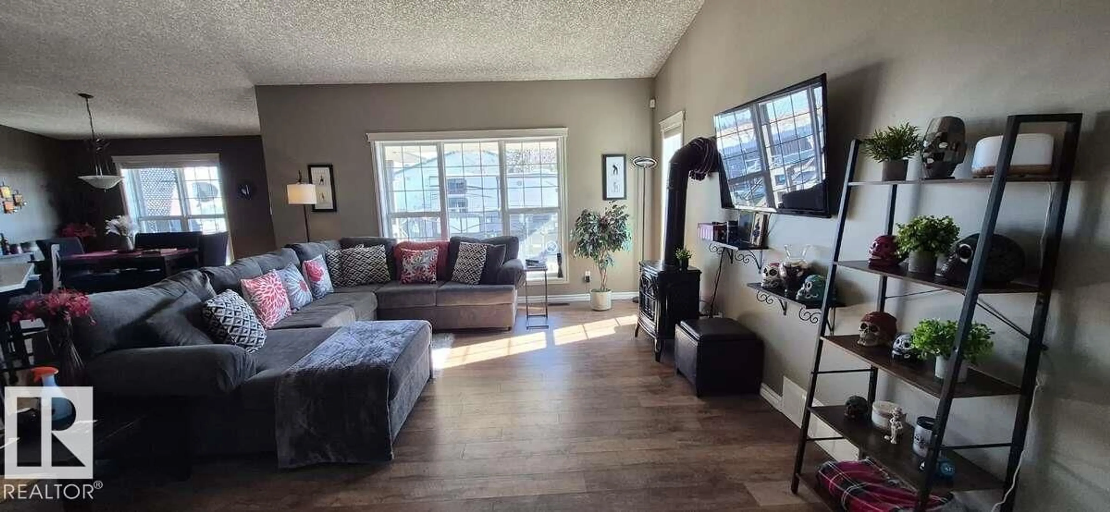 Living room with furniture, wood/laminate floor for 4235 55 AV, Tofield Alberta T0B4J0