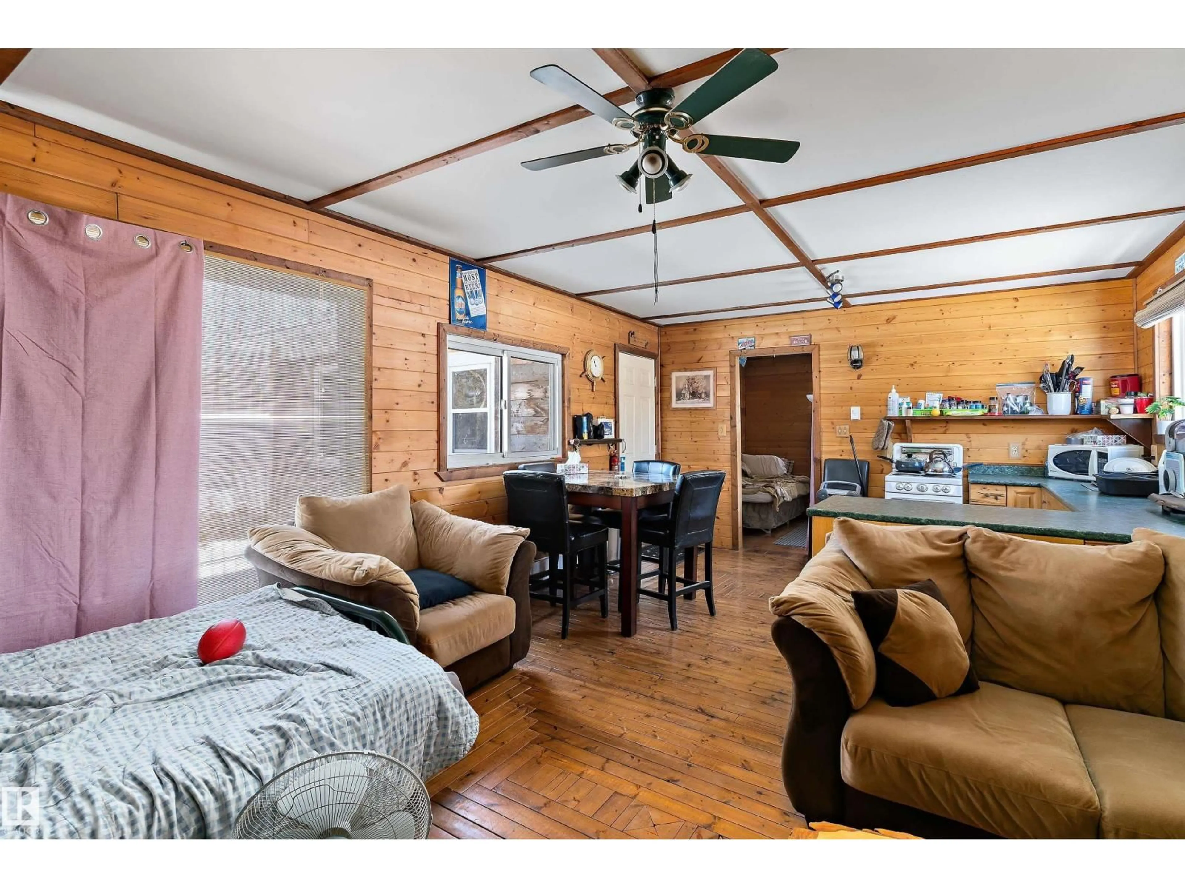 Living room with furniture, wood/laminate floor for #102 - 5124 TWP ROAD 554, Rural Lac Ste. Anne County Alberta T0E0L0