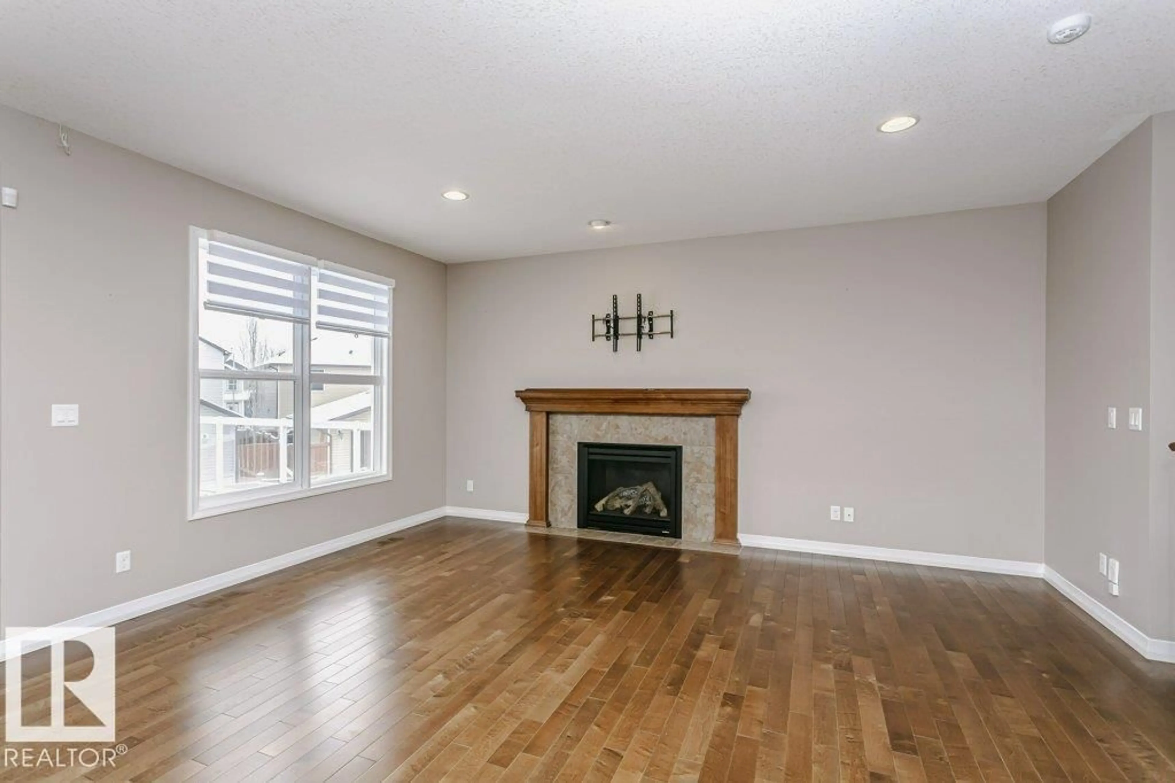 Living room with furniture, wood/laminate floor for 16861 58A ST NW, Edmonton Alberta T5Y0N1