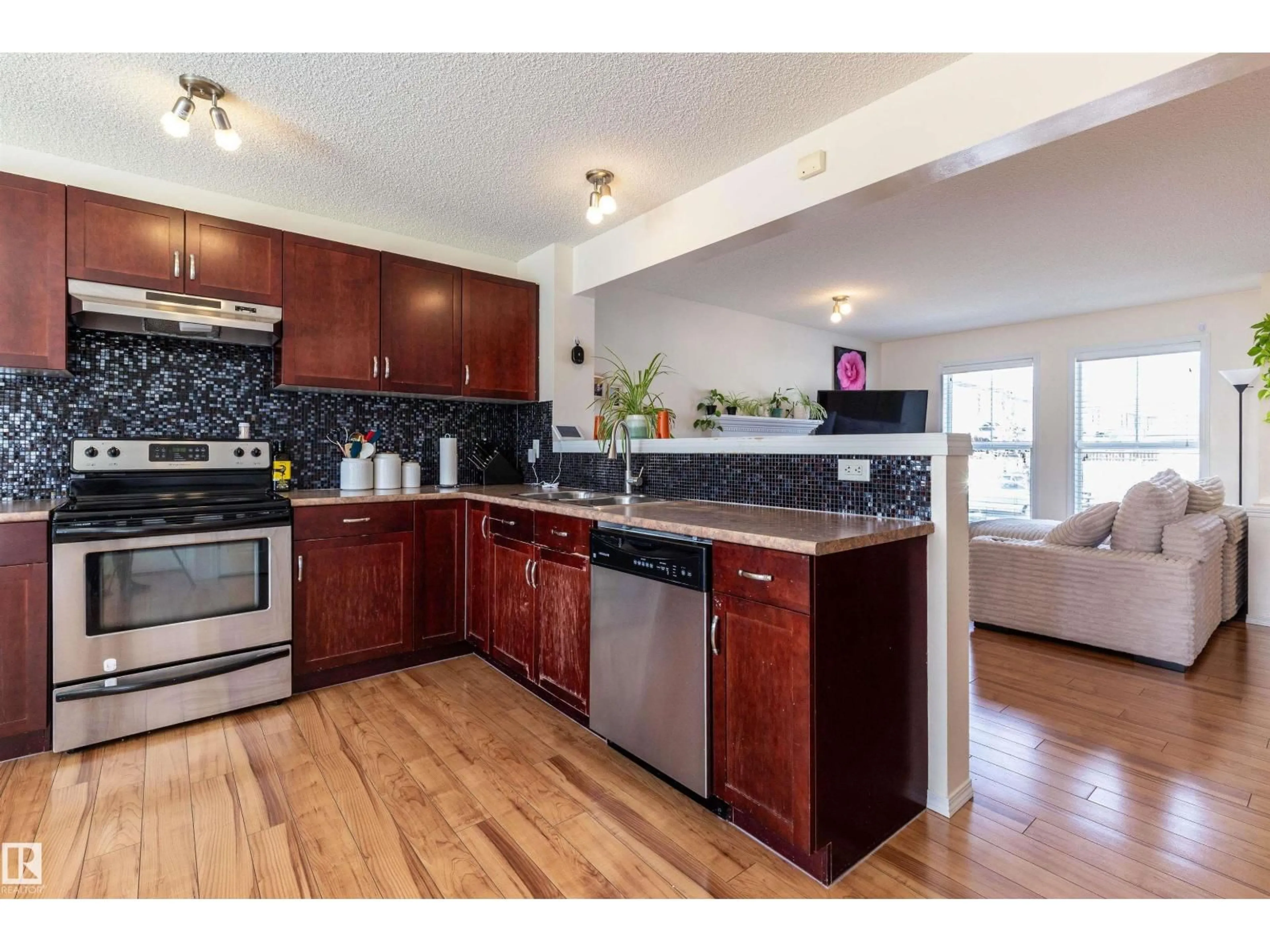 Open concept kitchen, wood/laminate floor for 21313 60 AV, Edmonton Alberta T6M0H8