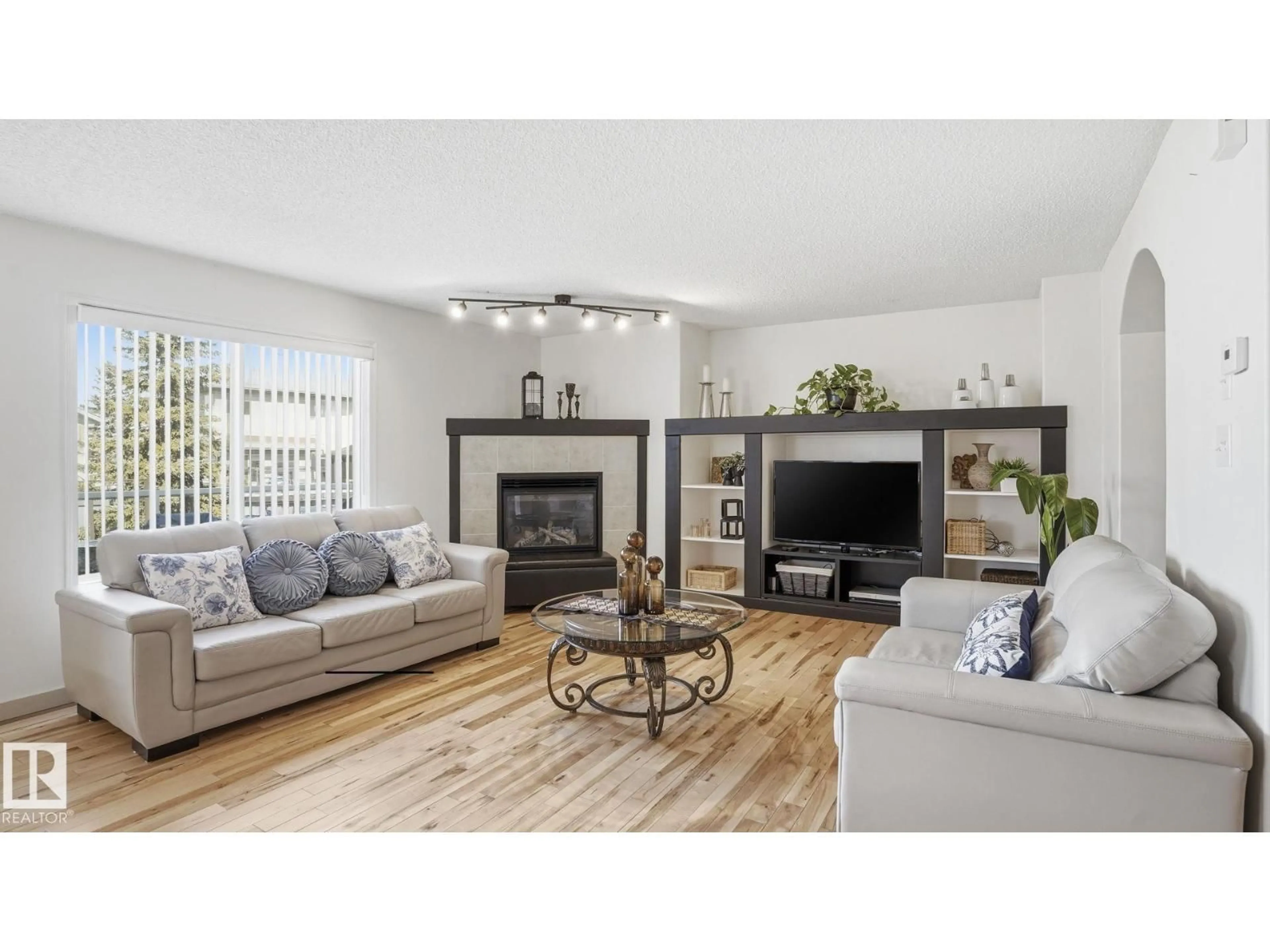 Living room with furniture, wood/laminate floor for 1310 BARNES CL, Edmonton Alberta T6W1E5