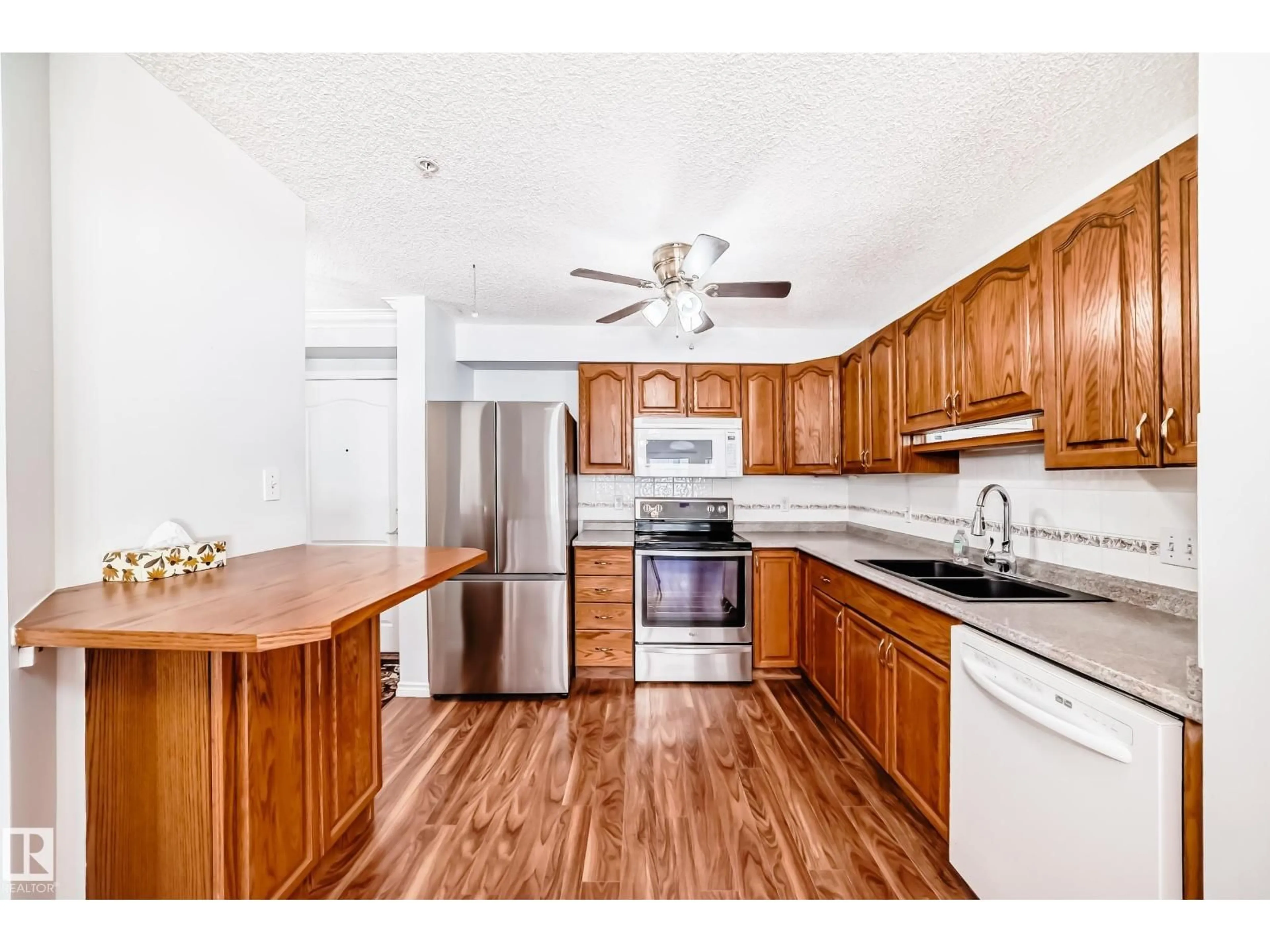 Open concept kitchen, wood/laminate floor for #112 - 17150 94A AV, Edmonton Alberta T5T6L7