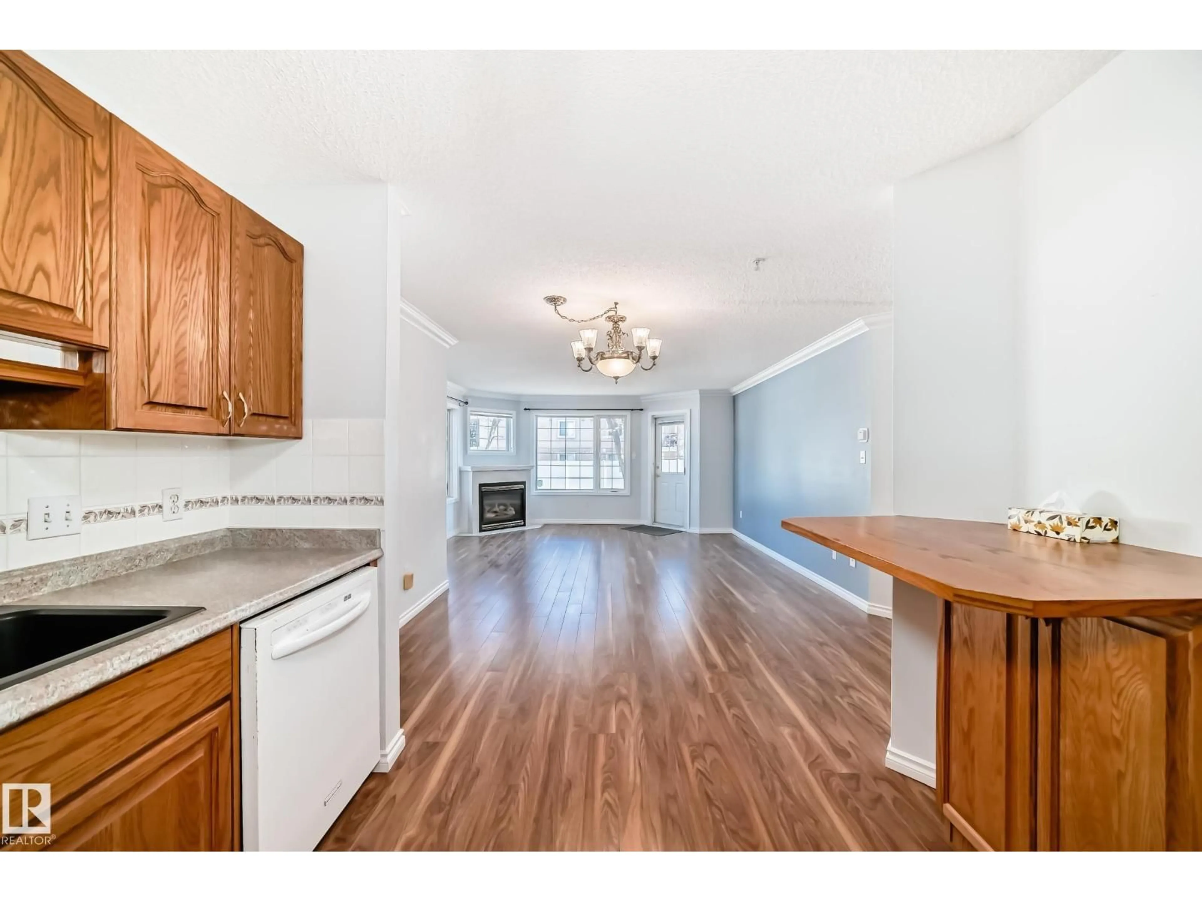 Open concept kitchen, wood/laminate floor for #112 - 17150 94A AV, Edmonton Alberta T5T6L7